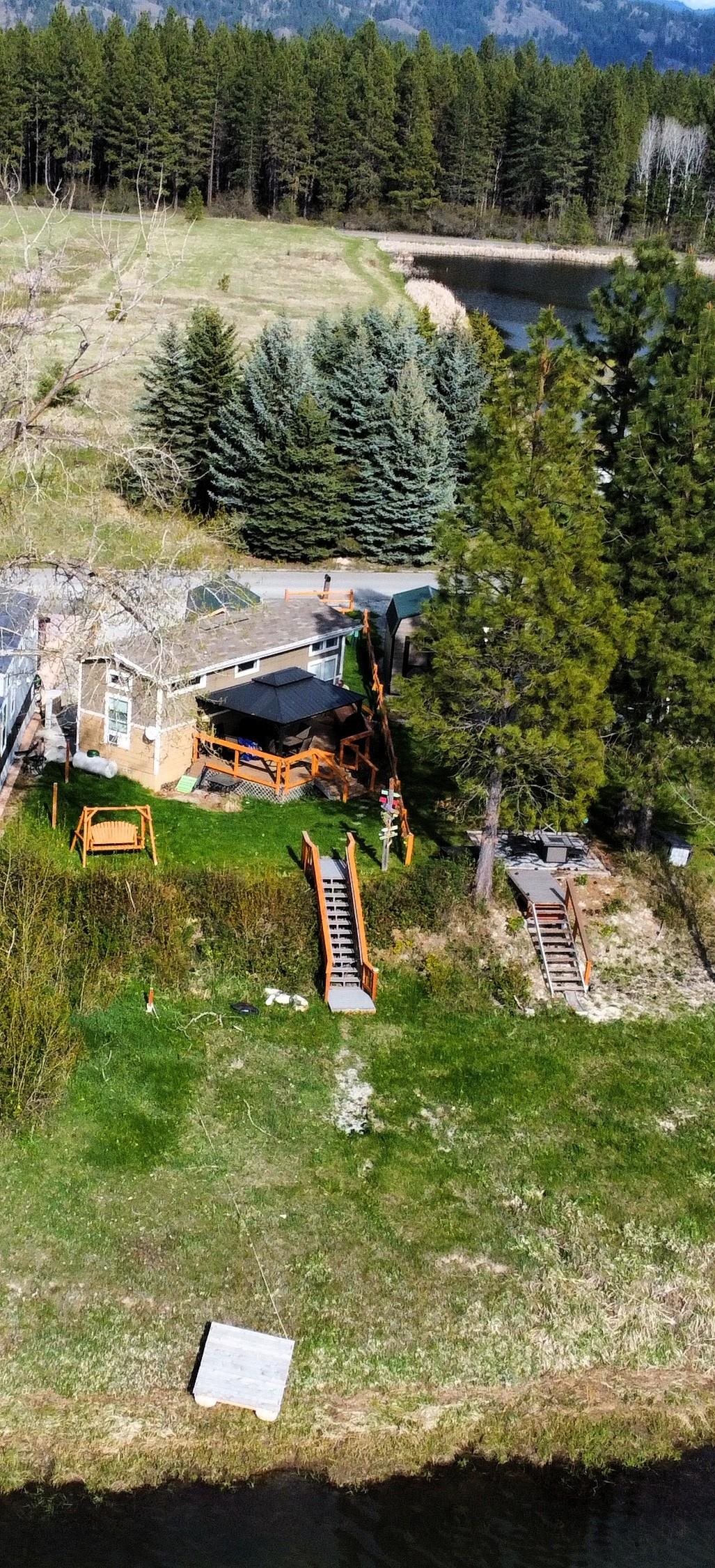 Come home to this GORGEOUS primary waterfront property with stunning river views!! Enjoy summer on the river!  Magnificent sunsets, wildlife and even resident eagles at this desirable turnkey property. Escape to this charming 2020 home, set against the calm backdrop of Pend Oreille River & surrounding mountains. The open-concept design creates a spacious atmosphere that maximizes natural light and river views. The kitchen boasts sleek stainless steel appliances and eating bar while the spacious bathroom includes a large walk-in tile shower. Bedroom with a river view fits a king sized bed and has double closets. This tranquil retreat features an expansive yard, perfect for entertaining or unwinding, cozy bunk shed with loft for extra guests, complete with a large gazebo for serene outdoor moments. With convenient access to nearby amenities and endless recreational opportunities, this home is a rare gem that blends luxury, nature, and relaxation—ready for you to make it your own!