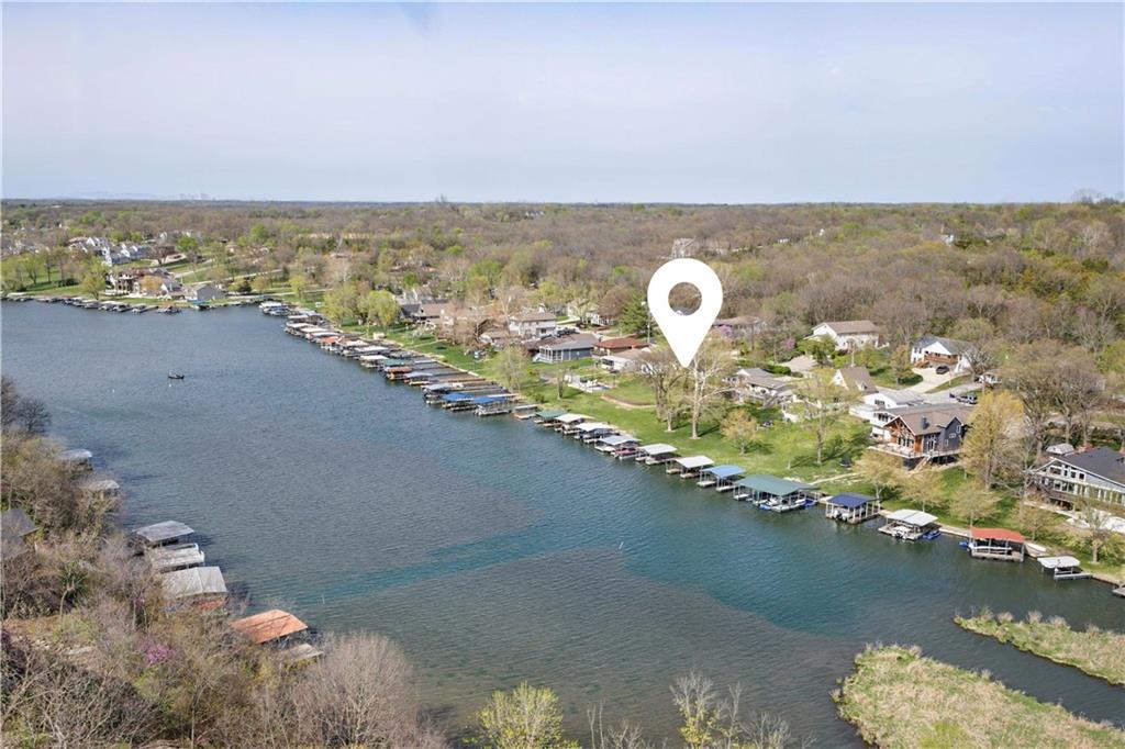 LAKE LIFE STARTS HERE! Opportunities like this rarely come along. Tucked away on a double lakefront lot in a peaceful no-wake cove overlooking picturesque Sunrise Bay, this property offers the setting buyers dream about—private, serene, and complete with your own dock. With no through traffic, you'll enjoy uninterrupted lake views, spectacular sunsets, and the perfect place to relax, entertain, and create lasting memories. The sprawling ranch has already cleared the first hurdle for renovation enthusiasts. Featuring a newer roof and updated copper plumbing, the home has been taken down to the studs and is ready for a complete transformation. Whether you're envisioning a luxury lakefront retreat, a modern showpiece, or the ultimate weekend getaway, this is your chance to design every detail exactly as you want it. Bring your creativity and your vision—this is the lakefront blank canvas you've been waiting for! Plans and a contractor estimate are already attached to MLS, making your lakefront dream home closer than ever! At Lake Lotawana—the largest private lake in the Kansas City area—every day feels like vacation. Enjoy sailing regattas, speed boating, ice boating, pontoon cruising, kayaking, canoeing, water skiing, tubing, swimming, fishing tournaments and vibrant community events. Whether you crave peace and quiet or action on the water, this community has it all! Don’t miss your chance to create the ultimate lake lifestyle. Please note: bedroom and bathroom count reflects previous finished layout. The current owner had plans to completely renovate the home. See attached bid in MLS. NOTE Reminder: The $217,000 was a complete cost to renovate the home to a premium masterpiece. We see a projected ARV value of $1.3-1.5 million - check comparables.
