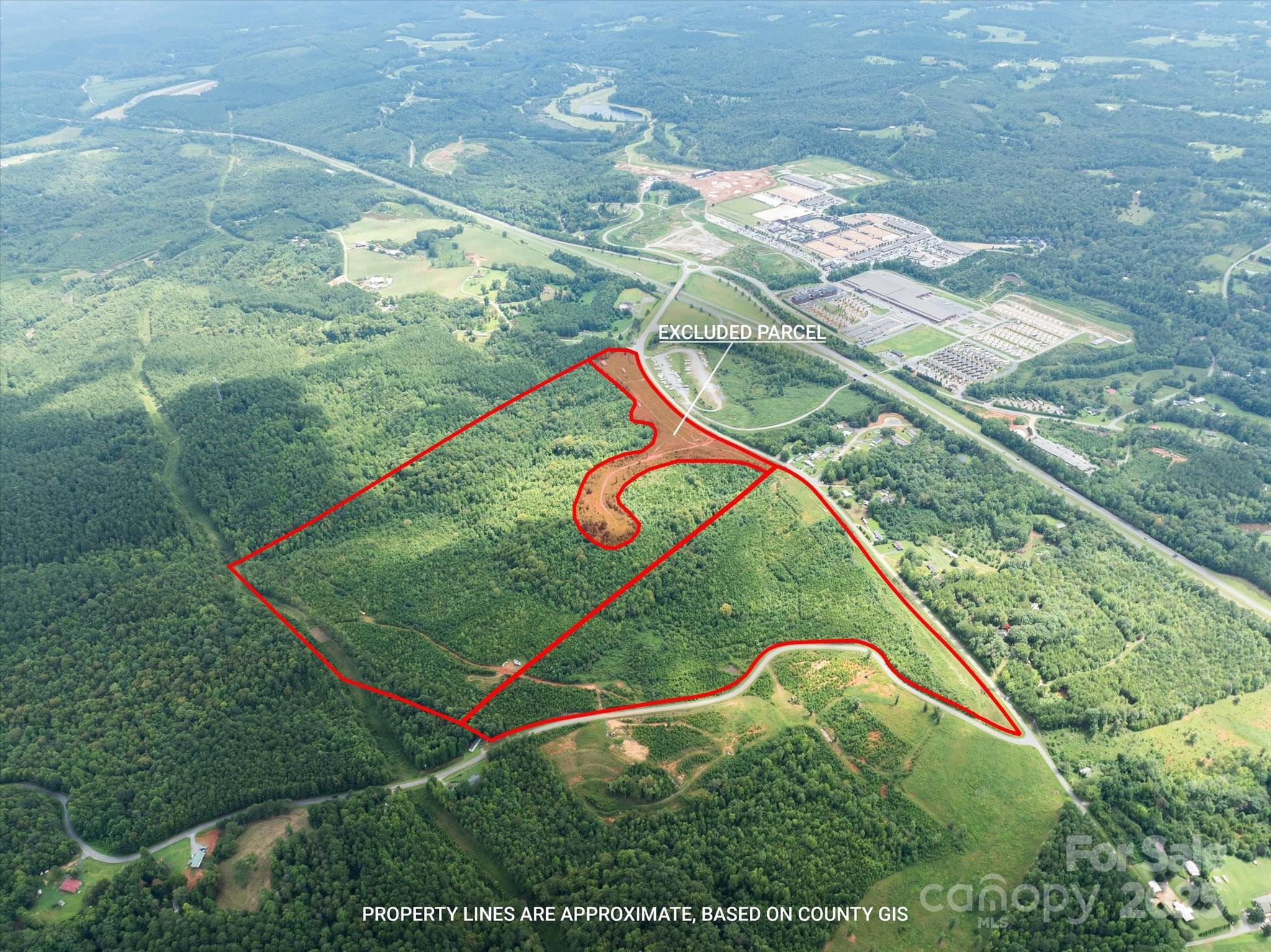 Don’t miss this exceptional 128-acre development opportunity with outstanding visibility along Highway 74, and an ideal location only 0.5 miles from Tryon International Equestrian Center! The property has been largely cleared with many interior soil road beds in place, also the workable topography showcases panoramic mountain views, making it perfectly suited for a wide range of residential or commercial projects. The site features an estimated 2,000 feet of frontage along Pea Ridge Road, and is strategically positioned just off the US 74 onramp with newer traffic circles for ease of access. Very nearby at the TIEC is a new 96-room hotel, along with the expansion of events and year round programming, underscoring the growth and investment momentum in the area. With its combination of prime location, versatile land use potential, and proximity to major regional amenities, this property represents a rare chance to secure a large-scale site in one of the region’s fastest-growing corridors.