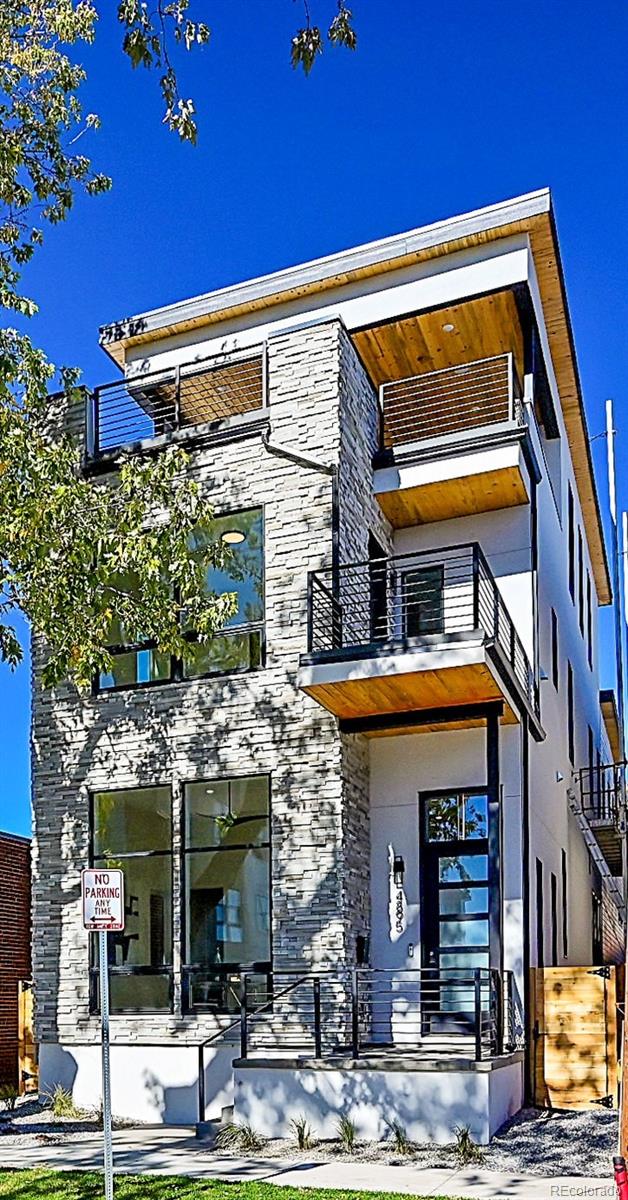 Welcome to your dream home 3,705 SQ FT above grade!! The main floor offers a grand ambiance with a spacious open floor plan, 11-foot-high ceilings and extensive natural light. The kitchen is a chef's paradise, featuring contemporary cabinetry, a gorgeous kitchen island 11 feet long, quartz countertops and high-end stainless-steel appliances.   Relax and unwind in the living room in front of the cozy fireplace. The stylish dining area has a built-in buffet making every meal feel like a special occasion. The primary bedroom is a true retreat with its 12 foot ceiling, attractive fireplace, private deck and massive custom walk-in closet while the primary bathroom is a spa-like oasis, featuring a steam shower, soaking tub and an impressive double vanity.  The 3rd floor is perhaps the most unique aspect of this lovely home, showcasing a spectacular entertainment area, extensive wet bar and striking covered roof deck with expansive views.  The unique sliding glass door completely retracts into the wall making it perfect for indoor/outdoor entertaining.  Beautiful new hot tub is included.  Don't miss out on this incredible property.  It really is a must see!