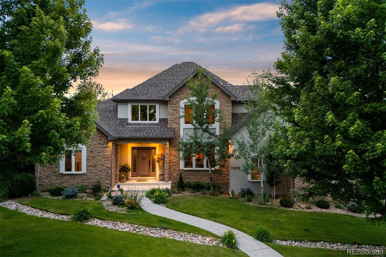 Imagine your own private park—lush, layered, and thoughtfully designed for connection, calm, and everyday ease. Trees tower, gardens and paths wind, and patios invite you to linger beside a seasonal fountain and cozy fire pit. Designed with intention, the home offers main-floor living, updated finishes, and a natural flow that brings comfort and calm to daily life.  

Inside, the home balances openness and warmth with soaring ceilings, on-trend finishes, and rooms that feel both expansive and personal. Two story ceilings greet you in the foyer and natural light pours through clerestory windows in the formal dining room. The great room is grounded by a stacked stone fireplace and backyard views, while the kitchen keeps things fresh and functional with clean white cabinetry and newly added subway tile backsplash, a new gas cooktop, granite counters, and a sunny eat-in nook overlooking “the park”.  

The private main-level primary suite features its own fireplace and direct access to the yard, while upstairs, a flexible loft joins two spacious bedrooms and two bathrooms—including one with a vaulted ceiling, dormer window, and a private ensuite. 

The finished basement adds even more flexibility with a large rec room, two bedrooms, and generous storage. And throughout, details like new carpet, updated tile, fresh paint inside and out creates a polished, move-in-ready feel—no projects, just living. Set in the low tax, low HOA Plum Creek community, surrounded by rolling fairways and sweeping Front Range views, this home offers easy access to the golf course and a lifestyle rooted in connection, recreation, and natural beauty.