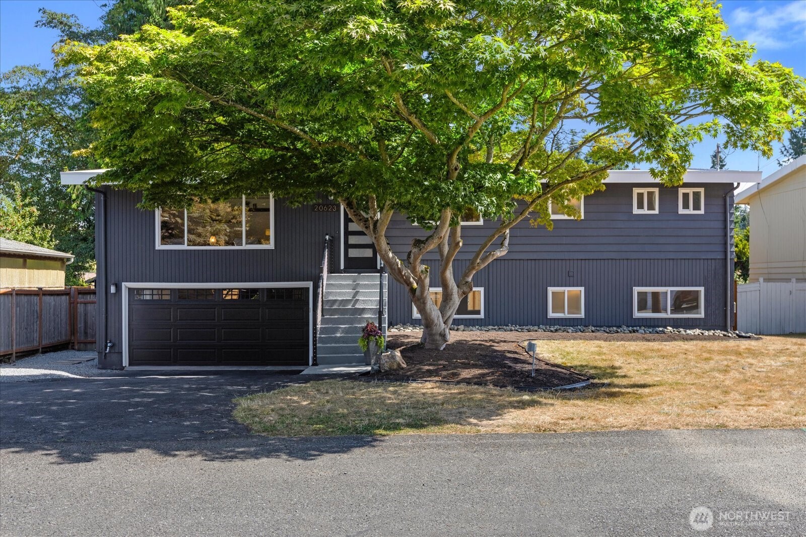 BEAUTIFUL TURN-KEY! Nestled on a quiet cul-de-sac in Edmonds, this completely remodeled home is just minutes from downtown and the waterfront, walking distance to Pine Ridge Park, and close to top-rated schools. All it needs is your personal touch!  A large open living room and woodburning fireplace welcome you to this two-level home. The main floor features refinished hardwood floors, all new cabinetry and quartz countertops throughout, LED lighting, a stunning new kitchen with new LG appliances, and new French doors onto a brand new expanded deck.   Also featured is a new Primary with en suite bath and expansive walk-in closet. There is a second bedroom on the main floor, another all-new full bath with dual sinks, a tub shower, and Kohler hardware, and a generous laundry with sink.   A redesigned staircase leads to the lower level with its own entry, a spacious recreation/family room, a second woodburning fireplace, a full bath, two additional bedrooms, new carpet, and an attached two-car garage. The lower level could be its own separate living space!  New French doors lead out into a large level backyard with new cedar fencing. Plenty of room for a garden, a firepit, and even a trampoline! Nothing left to do but ENJOY!!