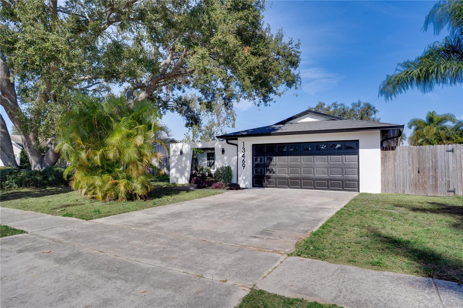 This 3 bedroom, 2 bath Largo home features a private in-ground pool and a fully fenced backyard, creating the perfect setup for everyday living and entertaining. Inside, you’ll find a beautifully updated interior with fresh paint, LVP flooring throughout, and a bright open layout that seamlessly connects the living room, dining area, and kitchen. The kitchen stands out with stone countertops, stainless steel appliances, a stunning backsplash, recessed lighting, and an island that opens directly to the main living space, all enhanced by vaulted ceilings that bring in natural light and volume. The primary bedroom offers a sleek en-suite with a walk-in shower. Major updates include a new roof and HVAC (2025), giving buyers peace of mind. Located just minutes from the water—but in a non-flood zone—you’re close to parks, beaches, shopping, dining, and entertainment. With short-term rental flexibility in Largo, this property also offers strong income potential and multiple use options.