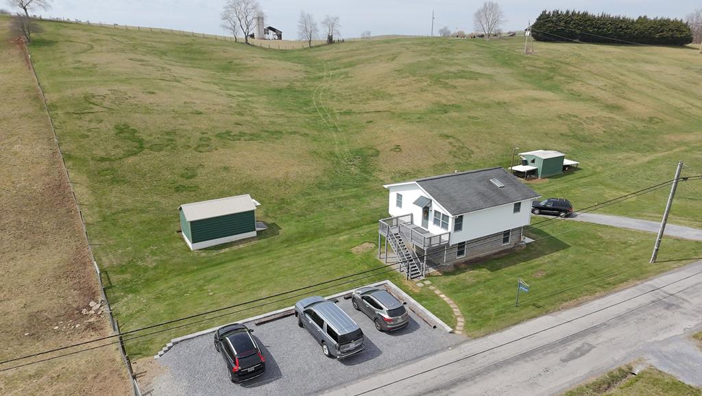 Serenity abounds in this well maintained 3 BR, 2 BA home that can be utilized as a one residence home with a mother-in-law suite on ground level, or use as two rental units while building your dream home on the acreage. Take in the fantastic views of the Iron Mountain Range of the Appalachian Mountains, yet just a ten minute drive to I-81 and US Hwy.11. Just another short drive to the South Fork of the Holston River with stocked trout fishing waters, or on to the Mt. Rogers National Recreation Area where you will find horseback riding, hiking, hunting & picnicking areas.  Two spacious storage buildings, two parking areas, public water, septic system - all already in place for your added convenience and usage.