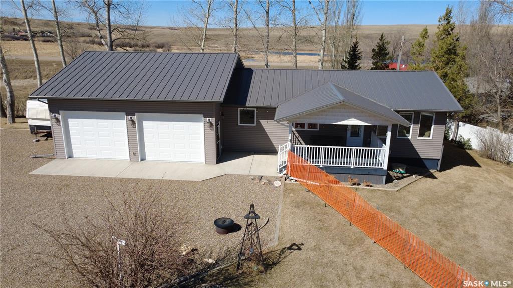 If lake life is calling but you still want the comfort of a solid, well-planned home, this Carefree Park property delivers in all the right ways. Just a 45-minute drive from Swift Current, #2 Fisherman’s Drive offers a relaxed resort setting with room to breathe and space to enjoy. The 1,176-sq.ft. home was built in 1993 and moved onto this property and a new basement in 2014 complete with weeping tile. In 2015, the 30x26 garage was added, built on 4’ piles with a 5” thick slab complete with rebar. It gives you all the space you need for a boat, water toys, and the usual lineup of lake gear, including a fish-cleaning station. Inside, the kitchen is equipped with oak cupboards and updated stainless-steel appliances, and flows naturally into the dining area. The living room view captures wide prairie views to the east, with easy access to the covered deck for morning coffee or winding down in the evening, adding a sense of openness that’s hard to replicate. On the main floor, you’ll find three bedrooms, a full bath, and laundry all conveniently located, while the lower level offers a huge fourth bedroom, a three-piece bath, and a generous rec space. Set on a large, partially fenced lot with mature trees, the property also features plenty of parking for RVs or company. A reliable 50’ well with 30” cribbing was drilled around 2008 and had a 13 gal./min. flow at that time. The septic system is a single-chamber 2,000-gal. fiberglass tank that was installed in 2015. Extras include central vac, a reverse osmosis water treatment system, a high-efficiency propane furnace, PVC windows, vinyl siding with added insulation underneath, a metal roof, and joint ownership in a dock! Lake days, prairie sunsets, and room for every toy you own… this is the kind of place people talk about owning someday but rarely get the chance to make it happen. Don’t let it slip past you.