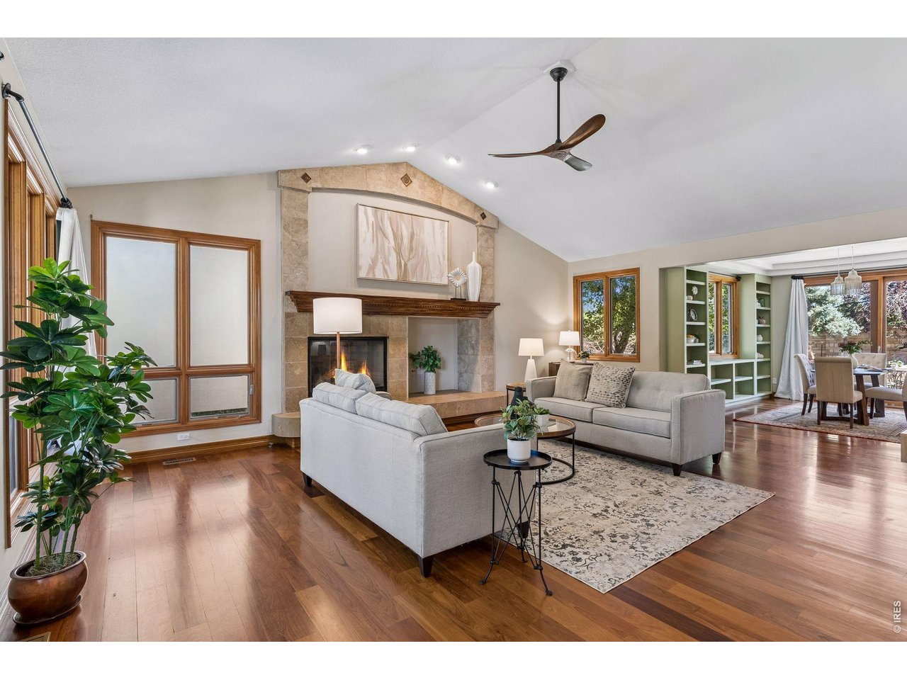 Set in sought-after Somerset Meadows in southwest Longmont, this exceptional custom home blends timeless craftsmanship, warmth, and livable luxury with a peaceful setting of mature trees, parks, ponds, open space, and beautiful mountain views. Inside, soaring ceilings, expansive windows, Brazilian walnut hardwood floors, hand-troweled plaster walls, and distinctive architectural details create an understated Old World-meets-Colorado character. At the heart of the home, the spacious kitchen features a substantial granite island, cherry cabinetry, copper sink, abundant storage, and a picture window overlooking the backyard pond and waterfall. The adjoining breakfast room opens directly outdoors, while gracious living and dining spaces make entertaining effortless. A private main-level study with an adjacent three-quarter bath offers flexibility for work or guests. Upstairs, four spacious bedrooms include a beautiful primary suite with views, a luxurious bath, and thoughtfully designed built-ins and closets. A secondary bedroom has an en suite bath, while two additional bedrooms share another generous bath. The finished lower level feels like a true extension of the home, with high-end finishes, a family room, wet bar, built-in surround sound, game space, an additional bedroom and bath, and abundant storage. Outside, a private backyard retreat features a pond and waterfall, stone walls, patio, pergola, mature landscaping, and a fruit-bearing grapevine-an inviting setting for entertaining or simply enjoying a quiet Colorado evening. Beautifully crafted, wonderfully private, and designed for real life, this is a home equally suited to everyday living, gathering with friends, and celebrating life's milestones. A place for living, loving, and making memories that last.