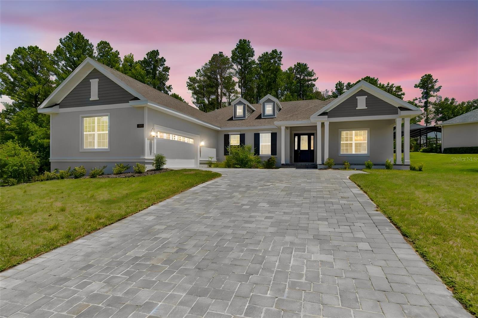 Virtually Staged. Set on an oversized homesite on almost a half an acre, this gorgeous Azalea model home offers 3 bedrooms, 3 baths, and 2,606 square feet of thoughtfully designed living space in one of Tampa Bay's most prestigious gated golf communities. A pavered driveway leads to a home where quality is apparent from the moment you walk in — tall coffered ceilings, 8-foot doors, and 5¼" moldings set the tone for an open floor plan that seamlessly joins the great room, dining area, and gourmet kitchen.The kitchen is spectacular: a 36" gas cooktop, 42" white shaker soft-close cabinets, quartz countertops, a huge center island with seating, subway tile backsplash, and under-cabinet lighting create a space built for both everyday living and entertaining. A rare BUTLER'S PANTRY — complete with sink, double cabinets, and space for a wine fridge — adds abundant storage and prep space, making this any host's dream.The split floor plan ensures privacy for everyone. Both guest bedrooms offer walk-in closets, with one functioning as a second owner's suite complete with its own private bath — ideal for multigenerational living or guests. A versatile den/office provides flexible space for working from home or as a formal living room. The Owner's Retreat is a true sanctuary, featuring a tall coffered ceiling, a huge walk-in closet, individual vanities surrounding the entire bathroom, and a frameless glass shower.Luxury vinyl flooring with a lifetime warranty runs throughout all main living areas, complemented by a tankless gas water heater and four gas outlets for greater efficiency. The spacious covered lanai is plumbed with both gas and water, ready for an outdoor kitchen — and your future pool oasis awaits in the wide, private backyard. A 651-square-foot, side-entry, 3-car-wide garage offers exceptional storage for vehicles, gear, and hobbies alike.Beyond the front door, residents enjoy life in Southern Hills Plantation, a gated, master-planned community set amid the rare rolling topography of Brooksville, Florida, with elevation changes of more than 200 feet and long-range views stretching nearly 20 miles toward the Gulf Coast. At the heart of the community is the private, 18-hole Pete Dye championship golf course — rated among the Top 100 residential courses in the United States by Golfweek and named a Top 50 New Course in the U.S. — along with a 6-hole par-3 course, driving range, and full practice facilities. The 20,000-square-foot clubhouse, styled after a classic old Florida estate, anchors a resort-style lifestyle that includes a full-service spa and fitness center, four tennis courts, a resort-style pool, and miles of scenic walking trails. In 2026, the club joined Heritage Golf Group, bringing continued investment in amenities and member programming.Minutes from I-75 and the Suncoast Parkway, and just a short drive to historic downtown Brooksville, this home offers the rare combination of a spacious private lot, resort-style community amenities, and easy connectivity — with Tampa's dining, culture, and airport all within easy reach.