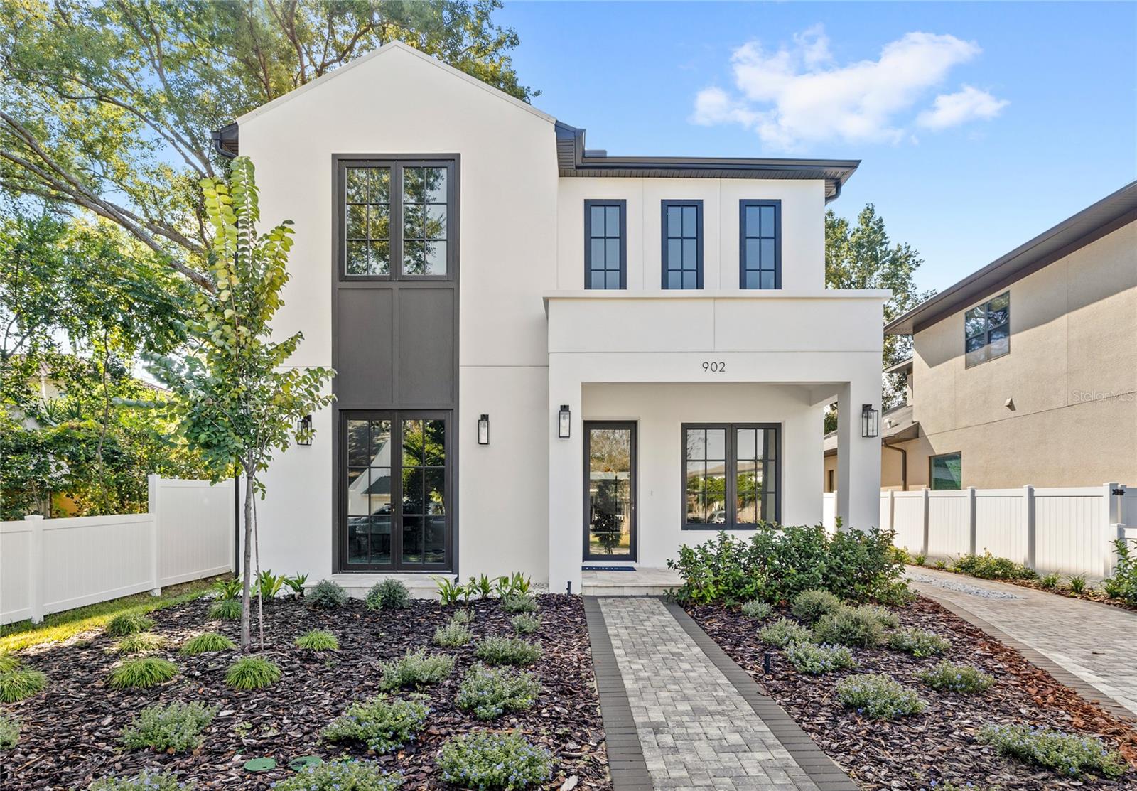 Edgewater Drive is literally steps from your front door in this brand-new College Park stunner. A transitional Luih Homes creation planted right in the middle of one of Orlando’s most walkable, character-packed neighborhoods. Zoned for Edgewater High and College Park Middle, you’re surrounded by everything that makes this area iconic: local restaurants, boutique shops, parks, and a true “live local” lifestyle all within a one-mile radius.College Park just celebrated its centennial, so while you’re moving into a piece of Orlando history, you also get the rare gift of living in a brand new, high-end build. The bold architectural lines, manicured landscaping, and private extended driveway leading to a detached two-car garage set the tone for what’s inside.Step through the front door and you’re met with soaring ceilings, oversized glass sliders, designer lighting, and a bright, open layout that feels intentional in every direction. The chef’s kitchen is both a showpiece and a workhorse, with waterfall quartz counters, Thermador appliances, custom cabinetry, a walk-in pantry, and a sleek wet bar complete with wine refrigeration and subtle LED under-lighting. Hosting here? Effortless. The kitchen, dining, and living areas blend seamlessly for laid-back nights in or full-scale dinner parties.The primary suite reads like your own quiet retreat. Drenched in natural light and anchored by a spa-inspired bathroom with a freestanding soaking tub, oversized walk-in shower, dual vanities, and a generous custom closet. A downstairs sitting room, upstairs loft, and storage throughout add even more flexibility to the home’s layout.Dubsdread Golf Course becomes your personal playground, and the Tap Room is right there with some of the best food in Orlando. And when the holidays roll around? Holiday on the Drive brings the whole community together. Add in the brand-new Packing District minutes away with its food hall, new YMCA, and 45,000-square-foot rock-climbing facility, and weekends never have to be boring again.This is a lifestyle upgrade in one of Orlando’s coolest, most beloved neighborhoods, delivered in a fresh, modern package by LUIH.
