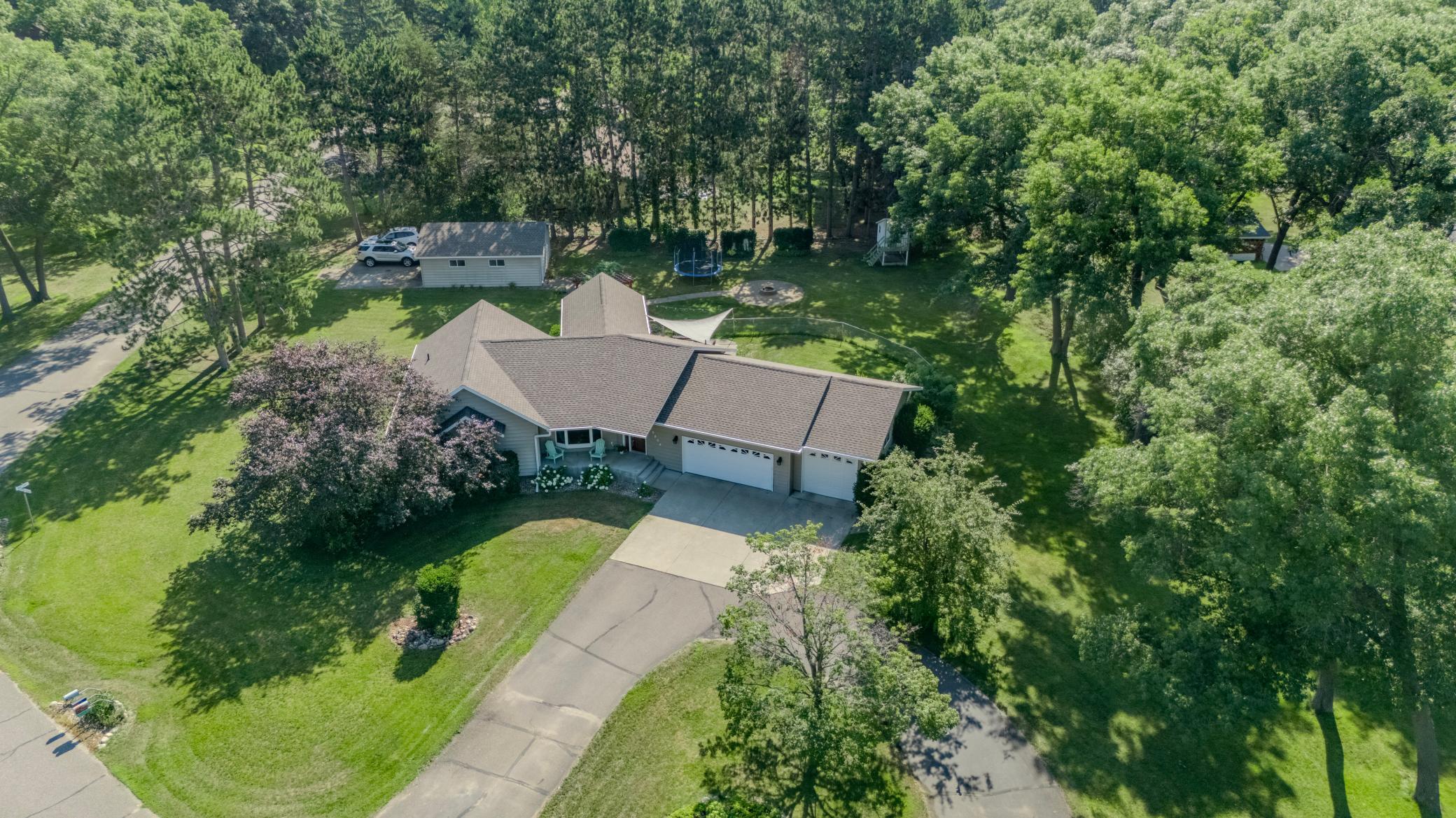 Spacious, solid, well built home that has amazing layout with bonus rooms and large corner landscaped lot with extra garage on 1 Acre! Tons of features such as built-ins in the office (5th bedroom option), 2 gas fireplaces, private owner's suite with walk-in closet & much more!  Flex rooms such as the 4 season sun room leading to patio with 2 outdoor fire pits and fenced area!  Basement has generous rec room plus another flex room with built ins, laundry and utility room plus storage room!  Updates: new high end refrigerator, new microwave, painting, lighting, ceiling fans, furnace humifier, new carpet in primary bedroom, smart thermostat and sprinkler system controls, 100" projector in basement and sound bar stays!!  Grapevines on back privacy fences, dwarf lilacs, flowering crabs & great appeal inside and outside this home! Best price per square foot value just on the edge of town!!