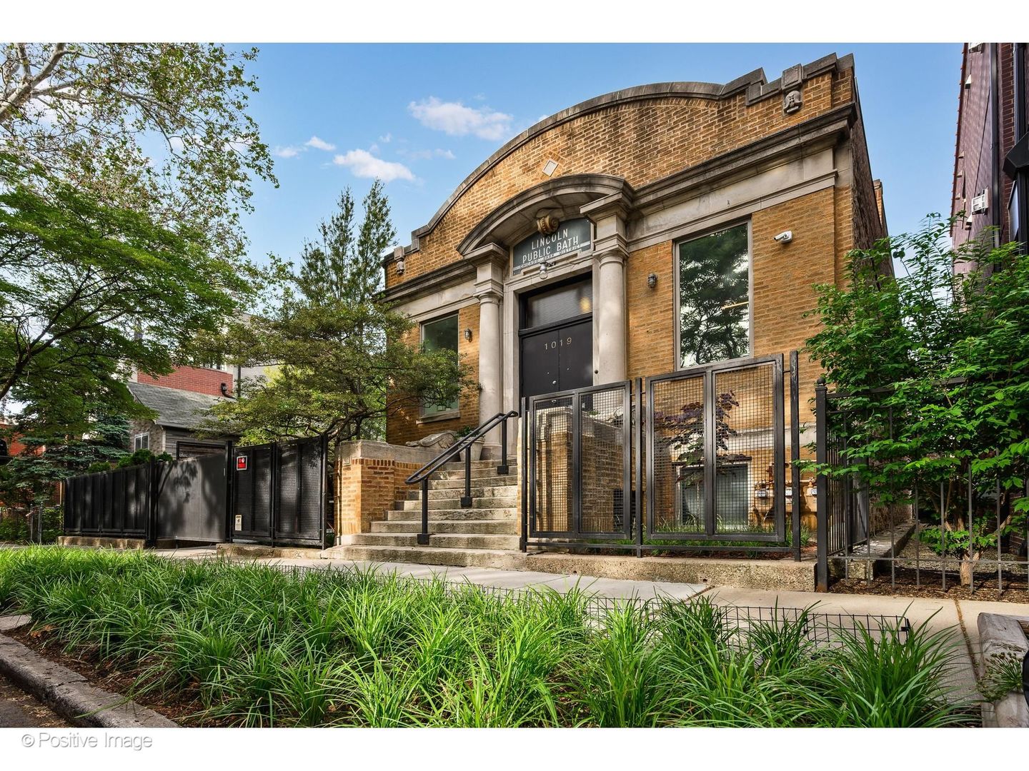 The Lincoln Street Bath House is one of Chicago's most extraordinary and versatile residential offerings. This historical masterpiece seamlessly blends modern luxury with iconic neoclassical architecture. Spanning approximately 10,000 square feet across two-and-a-half city lots, this one-of-a-kind, highly adaptable property presents a rare opportunity for multi-generational living, live/work functionality, event hosting, and income-producing potential - all within an exceptionally private setting. Originally transformed from a historic bath house into a spectacular private residence, the home offers dramatic scale and unforgettable design at every turn. A soaring, light-filled great room with designer lighting, state-of-the-art A/V, and expansive entertaining spaces creates the perfect backdrop for both intimate daily living and large-scale gatherings. The sleek stainless-steel chef's kitchen anchors the home with modern functionality. The luxurious primary suite serves as a peaceful private retreat with a freshly updated en-suite bathroom- offering a serene escape from the energy of city living. Thoughtfully designed for flexibility, the lower-level features two beautifully appointed furnished units ideal for extended family, guests, au pair quarters, home office suites, or income-producing rentals. Whether accommodating multiple generations under one roof or offsetting ownership costs with rental income, the property offers an incredibly rare level of adaptability for today's evolving lifestyles. The home's sprawling layout and private compound-like feel also make it uniquely suited for creatives, entrepreneurs, collectors, entertainers, or anyone seeking substantial live/work capabilities without sacrificing luxury or discretion. Outside, the professionally landscaped grounds offer extraordinary entertaining potential with custom pavers, integrated lighting, outdoor kitchen, full bar, and expansive green space perfect for hosting unforgettable events or enjoying quiet moments surrounded by nature. Beyond its architectural pedigree and exceptional versatility, the property embraces sustainable luxury with environmentally conscious geothermal systems delivering energy-efficient living rarely found at this scale. Convenient attached garage parking plus additional exterior spaces complete this truly singular offering. The Lincoln Street Bath House is far more than a home - it is a private urban sanctuary, an investment opportunity, and a living work of art unlike anything else in Chicago.