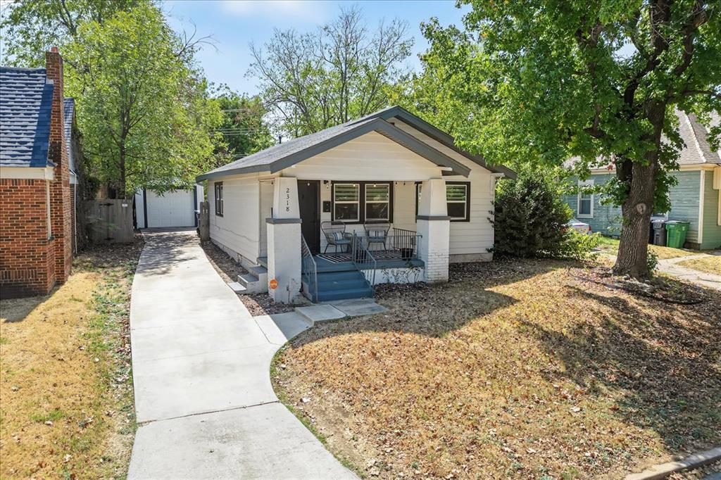 Charming 1932 bungalow offering timeless character with thoughtful modern updates in a convenient central OKC location. The inviting interior features refinished hardwood floors, fresh interior and exterior paint, updated lighting and plumbing fixtures, and beautifully remodeled bathrooms with updated tile and fixtures. The updated kitchen showcases new cabinetry, quartz countertops, stainless-steel appliances, and a spacious peninsula providing additional prep and seating space. Large windows bring abundant natural light throughout the home. Outside, enjoy a covered porch and private back patio, plus a detached one-car garage. Situated on an approximately 0.17-acre interior lot with convenient access to the Plaza District, Paseo Arts District, Downtown and the NW 23rd corridor. A move-in-ready bungalow with character, updates, and an excellent central OKC location.