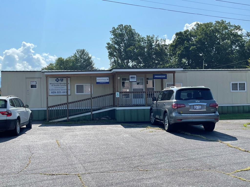 Business office. Great location right on Main Street in the middle of vibrant town of Andrews. Positioned across from the shopping center & adjacent to other well known Andrews based businesses. Location is prominent w/easy access/lots of parking. Great signage.  Large city lot with plenty of room for expansion. see rendering for 30+ storage units.  Great location in town of Andrews. Modular building w/New roof, new front porch & new accessible ramp. Well maintained and clean.  Divided into 2 rooms.  One large area for commerical use and one room that could be private liveable space or office and one bathroom with shower.   Has private direct fiber/ internet. seller has easement to fiber pole. Previous tenant generated 850.00 rent and with another tentant would make good investment property.