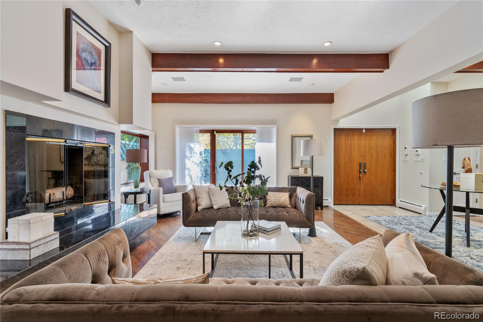 Elegance and warmth are the hallmarks of this this iconic contemporary Denver Country Club home. A gated hidden gem tucked behind high privacy walls, it was designed with a tranquil Japanese style exterior by noted architect, Ken Taniguchi. The interior, a wonderful flow of spacious and stylish rooms. Incredibly quiet and secluded feeling, yet it sits just a heartbeat away from Cherry Creek’s premier dining, boutiques, and art galleries. This truly top-notch location suggests a perfect Cherry Creek alternative, just out of the fray.As you enter through the charming enclosed courtyard, you're greeted by graceful contemporary architecture and large comfortable spaces  creating gorgeous settings for entertaining and daily living. A serene and welcoming Foyer opens to expansive Living and Dining Rooms, flowing to a wonderful chef's Kitchen with five burner gas range, large pantry, and exquisite custom cabinetry. A perfect private office with a bar, and a delightful Library/Den for relaxing complete the first level. Upstairs, a grand, sunny, and zen-like Primary Suite, and a second Bedroom Suite, both with private decks and incredible custom walk-in closets. Skylights and large windows fill every room with natural light, enhancing the home’s calming energy. Downstairs, a marvelous Family/Entertainment Room, mirrored Exercise Room, and impressive Wine Room add everything you could wish for in a home.Outdoors, discover a magical secret garden, peaceful patios, and multiple decks designed for intimate gatherings and quiet reflection, without the upkeep of a yard. With its imported Japanese porcelain tile roof, rich hardwood floors, and new carpet and paint throughout, this residence is a remarkable balance of aesthetic beauty, privacy, and livable sophistication. A rare and extraordinary opportunity in one of Denver’s most coveted neighborhoods.