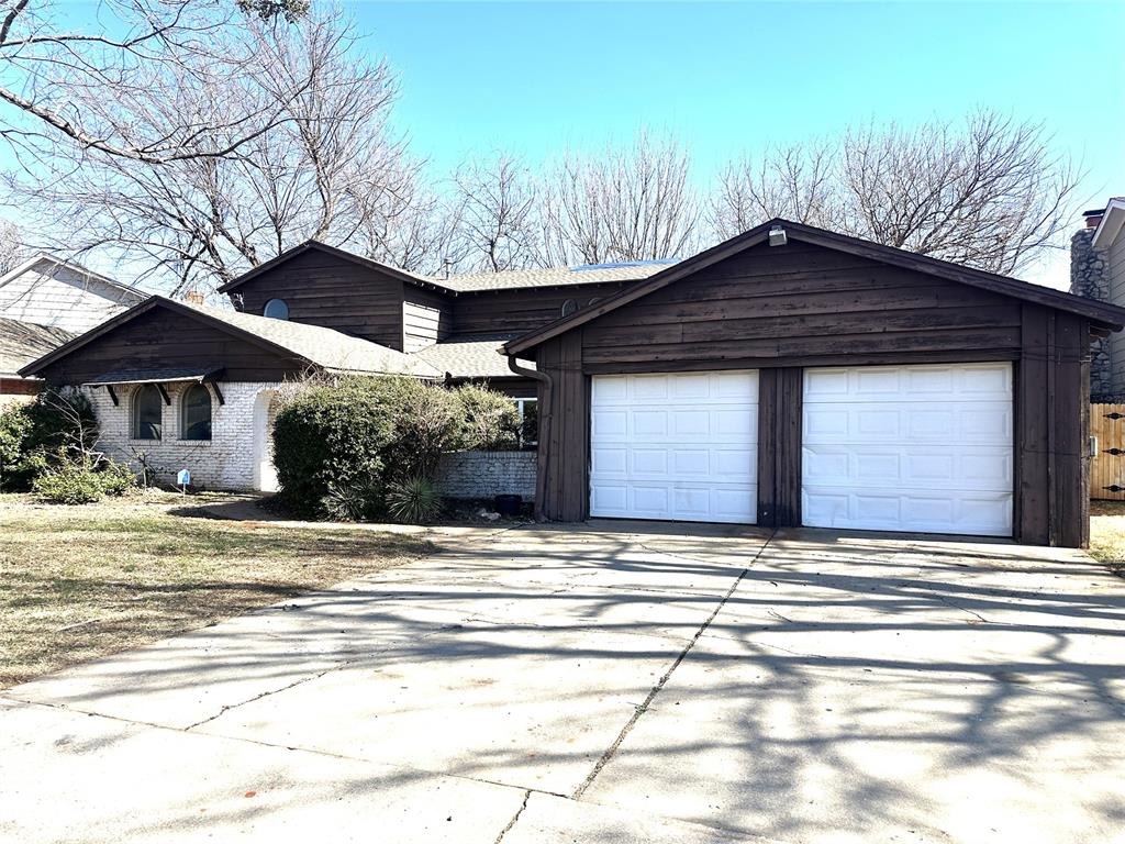 7212 Lancelot Place in NW Oklahoma City features 3,083 square feet, 5 bedrooms, 2 bathrooms, two living areas, and two dining areas. A brick fireplace with built-in bookshelves and a 2-car garage are included. Two bedrooms and one bathroom are located on the main level, with three bedrooms and one bathroom upstairs. Located in the Putnam City School District. Property presents an opportunity for investors or renovation-minded buyers.