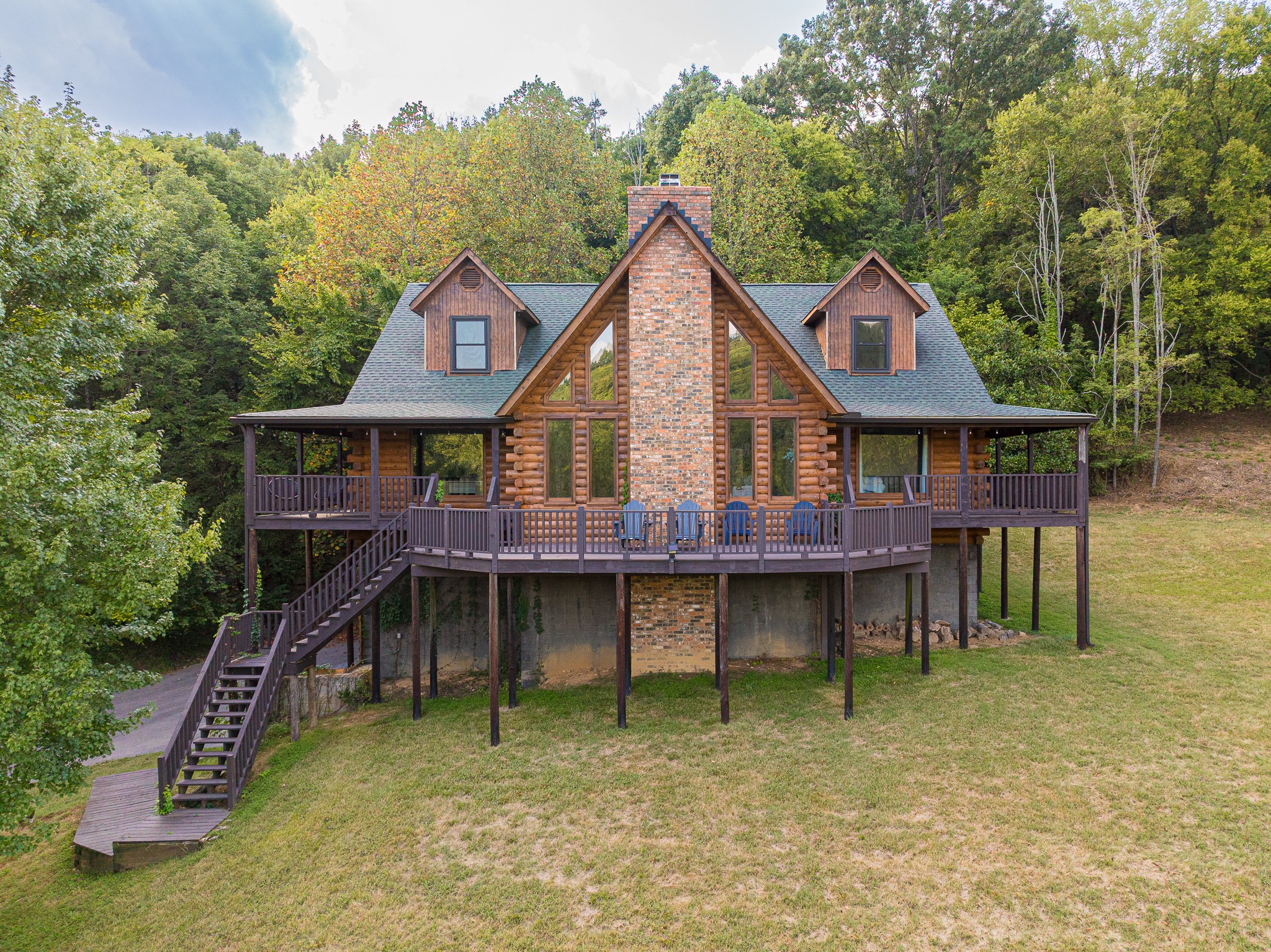 No HOA, five peaceful acres, and big-sky views—yes, please. Welcome to 1723 Warren Hollow Rd, a warm, log-built retreat wrapped in covered porches on all four sides, plus a center deck made for sunrise coffee and sunset unwinds. Step inside to a vaulted Great Room with eight sun-splashed windows and that classic cabin glow. The main level keeps life easy with a true primary suite and a flexible second room—perfect as a bedroom, office, or cozy den. (Septic is approved for 4 bedrooms.)
Upstairs, a lofted bonus overlooks the Great Room and leads to two private bedrooms—each with its own full bath and walk-in closet. The basement offers roughly 2,000 sq. ft. of unfinished space—already wired and plumbed—so dream big: media room, guest suite, hobby studio… you name it.
Thoughtful updates? You’ve got them: fresh asphalt driveway, full home log restoration/preservation, new back-entry stairs, plus selective land and tree clearing. Roof and HVAC were replaced within the past decade, and the water heater is just a couple of years old. All tucked into quiet, wooded privacy in coveted Warren Hollow—with strong short-term rental appeal (current owner books it often; buyer to verify STR eligibility). And the lifestyle only gets better: Nolensville is booming—Nolensville Town Square is underway, with new Publix and Kroger centers on the horizon, plus favorite local eateries, coffee, and parks. Need a bigger day out? Franklin is nearby offering CoolSprings Galleria shopping, golf courses, fine dining, and more. You'll love the peaceful country vibes without giving up everyday convenience. Buyer concessions offered!