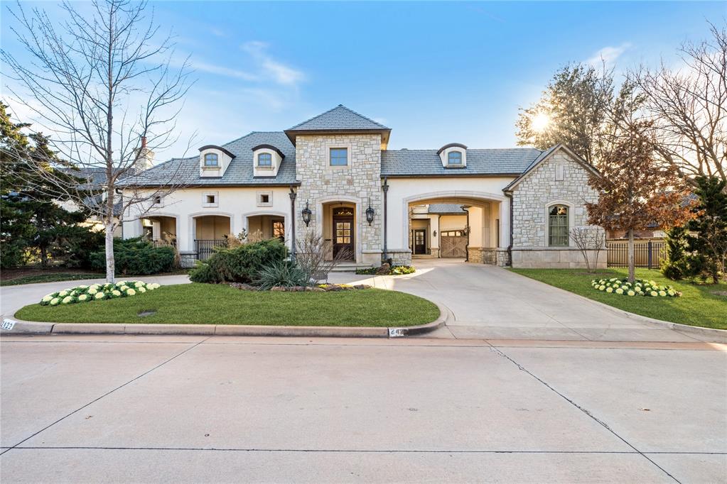 Nestled in one of the most coveted enclaves, 2422 Grand Circle is a showcase of timeless elegance, meticulous craftsmanship, and refined luxury. Designed for those who appreciate architectural excellence and effortless entertaining, this stately custom-built estate leaves no detail overlooked. From the moment you enter, you're greeted by soaring ceilings, exquisite mill work, and an abundance of natural light that floods the home through walls of windows, perfectly framing the lush, manicured landscaping beyond. Built for grand gatherings and intimate moments alike, the home offers two expansive, open-concept dining areas and a gourmet kitchen outfitted with imported marble countertops, a generous island, professional-grade appliances, and butler’s pantry. A wet bar, complete with ice maker and wine fridge, makes entertaining effortless. The main-level primary suite is a private retreat, featuring a spa-inspired bath with dual vanities, a spacious walk-in closet, and direct access to a serene patio oasis. Also on the main floor: executive office or secondary living area adorned with rich wood paneling and a statement fireplace, a guest suite, and two powder baths. Upstairs, you’ll find a flexible workout room, bonus living space with kitchenette and Murphy bed, and generously sized en suite bedroom. The private, low-maintenance backyard is designed for year-round enjoyment with an outdoor fireplace, elegant landscaping, and multiple areas to relax or entertain. A three-car garage and gated motor court offer both functionality and security. A rare opportunity to own a truly one-of-a-kind residence in a highly sought-after location. Experience the elegance of 2422 Grand Circle—where luxury lives.