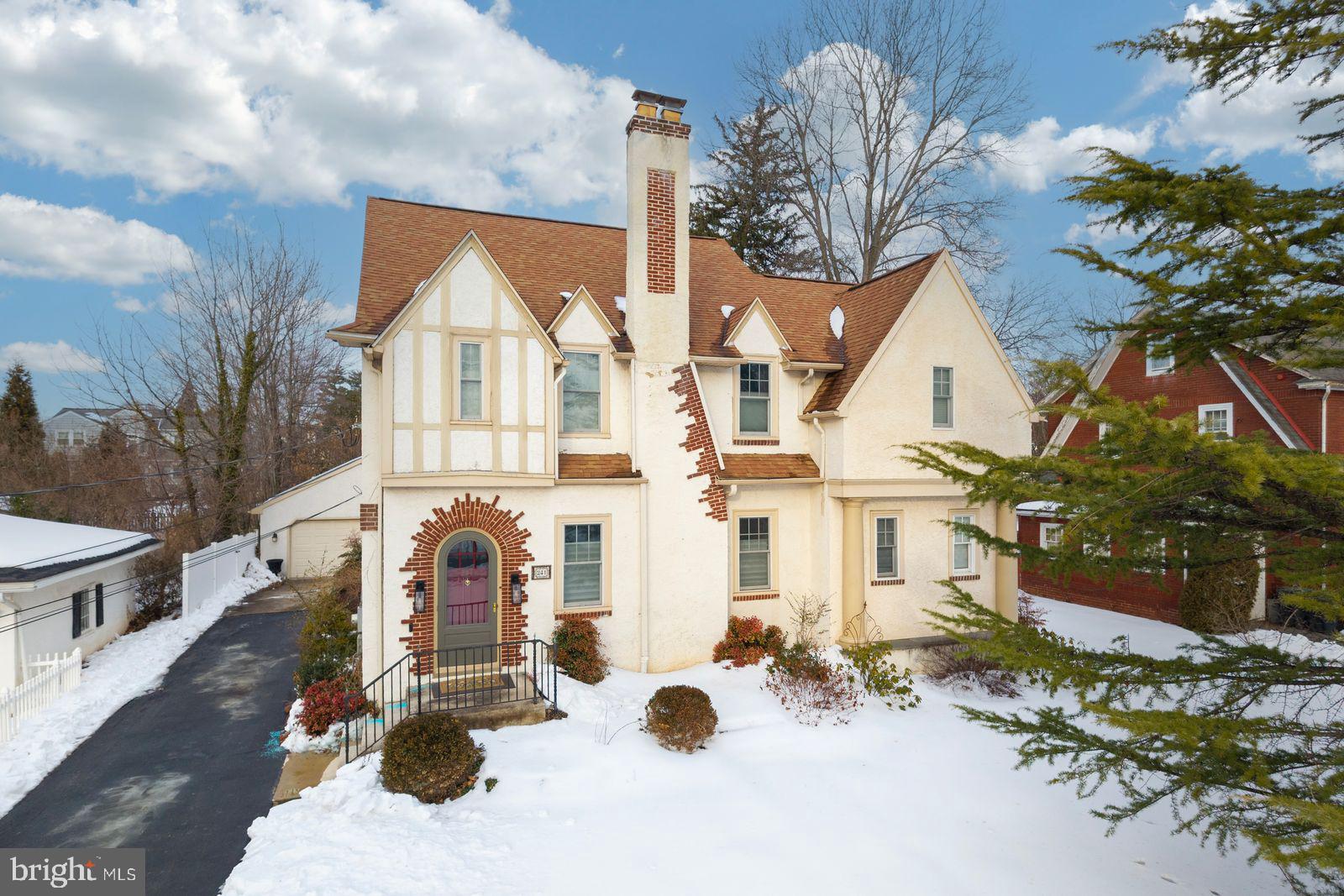 Welcome to 241 Anderson Ave, a stunning 3-bedroom, 2.5-bath Tudor-style home built in 1930 and perfectly situated on a picturesque, tree-lined street in the heart of Phoenixville Borough. This timeless gem seamlessly blends old-world charm with thoughtful modern updates, creating an ideal setting for comfortable everyday living and elegant entertaining.Step inside to discover generously sized rooms accented by original oak hardwood floors. The sun filled living room features a cozy wood burning fireplace and recessed lighting, while the spacious formal dining room complete with custom Levolor blinds is perfect for hosting memorable gatherings.The kitchen combines style and function with granite countertops, an undermount stainless steel sink, stainless steel appliances, and a travertine tile floor. The main level offers an effortless circular flow, providing abundant living space for both daily life and entertaining.Through an arched doorway, you’ll find a versatile den or home office with double doors leading to the patio and backyard. This space also includes a wet bar and convenient powder room perfect for guests.Upstairs, the private primary suite offers a walk-in oversized shower, walk-in closet and dedicated shoe closet. Two additional generously sized bedrooms, a full hall bath, and a cedar closet complete the second floor. The walk-up attic presents exciting potential for additional living space, a studio, or a creative retreat.Outside, enjoy beautifully landscaped grounds, a spacious backyard ideal for entertaining or gardening, and a private driveway leading to an oversized detached two-car garage with ample storage and off-street parking.Additional highlights include glass doorknobs that preserve the home’s historic character, updated 200-amp electric service, newer windows, and central air and heat.Ideally located near schools, parks, shopping, dining, and public transportation, this home offers unbeatable convenience in one of Phoenixville’s most desirable neighborhoods.This is more than just a home it’s a lifestyle. A rare opportunity to own a property that is both structurally sound and architecturally captivating. Schedule your private tour today!