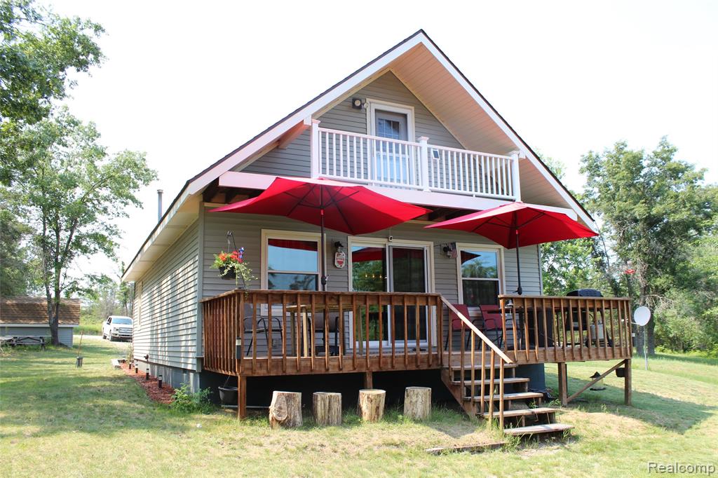 Welcome to your private 3 bedrooms 2 bath waterfront retreat on beautiful all-sports Mack Lake. This cozy chalet-style home is the perfect blend of charm and relaxed lake living! This home sits on nearly 1 acre with 400 feet of lake front and a boat dock. Located on county-maintained road, ensuring year-round access for lakeside relaxation and outdoor fun. Surrounded by forested land, within easy reach of hiking, ORV trails, wildlife spotting, and the Huron National Forest. Its functional design and knotty pine throughout creates a cozy retreat.  A new 24x40 pole barn was constructed to keep all the toys. Ideal as a year-round home, seasonal cottage, or investment property. Enjoy swimming, fishing, riding, hiking, and lake life! This property won't last long—don’t miss your chance to own a slice of paradise on Mack Lake. Schedule your private tour today.