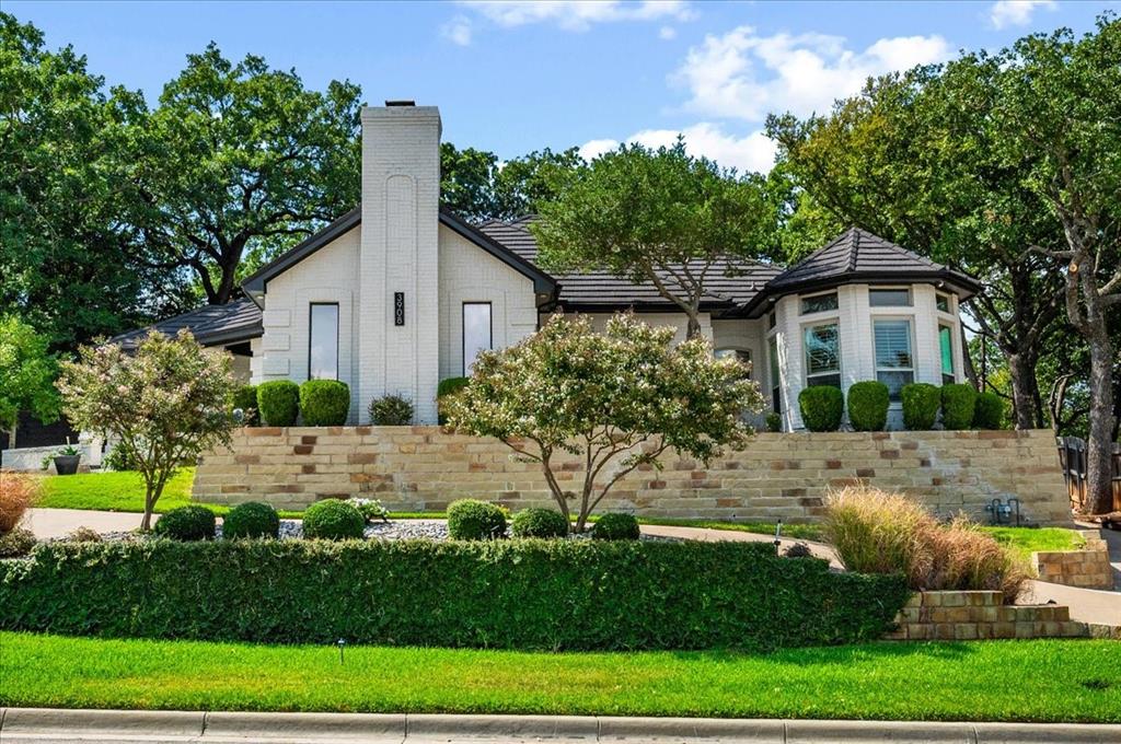 What if your home could feel like a luxury retreat AND your community felt like a vacation destination? That's what 3908 Woodstock Dr. in sought-after Windview Estates offers! This beautifully transformed 4-bedroom, 3-bath Colleyville residence delivers sophisticated style, exceptional updates, and spaces designed for both luxurious everyday living and effortless entertaining.The completely updated interior showcases gorgeous Quartzite countertops in the kitchen, wet bar, utility room, and one bath, complemented by beautiful hand-scraped wood flooring and elegant decorative lighting throughout. The spacious floor plan features two living areas, an upscale dining room, separate breakfast area, and a unique enclosed atrium that creates a beautiful private retreat. The sophisticated wet bar is perfect for entertaining guests.The expansive primary suite offers a luxurious ensuite bath and his-and-hers closets, while abundant storage throughout adds exceptional functionality. Recent improvements include a Class 4 metal roof replaced in 2021 and new insulation with an airtight attic completed in 2025.Windview Estates elevates the lifestyle even further with a large clubhouse, pool, courts, playground, green space, and more. A beautifully appointed home in a welcoming Colleyville community—where quality, comfort, and style come together. GCISD! Close to shopping, dining and highways. All information deemed correct but not guaranteed. Buyer or Buyer's agent to confirm.
