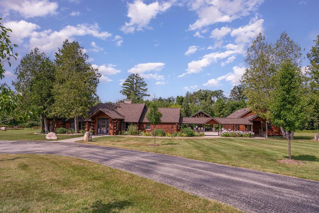 What an incredible find! Nestled in the heart of the Huron National Forest, this sprawling 220+ acre estate sits at the end of a half-mile private drive, bordered by over 20,000 acres of Huron National forest on 2.5 sides. The property features three meticulously remodeled homes offering more than 6100 square feet of finished living space in all. This includes the original log home with four bedrooms and two natural stone fireplaces, as well as six additional outbuildings. Floor-to-ceiling windows in the great room offer stunning views of the bountiful, beautiful wildlife. Step outside to a 20x30 pavilion with a stone fireplace, a 20x40 heated in-ground pool, and a pool shed. A 1,400 sq. ft. two-bedroom guest house is connected to the main home by a covered walkway. Across the asphalt drive sits a remodeled additional guest house, ideal for rental income or guests. All three homes are heated by an outdoor wood furnace along with independent force air heating and cooling systems and equipped with automatic backup generators. A circle drive includes two 230A 120V RV hookups. The 40x103 pole barn features a 23x40 heated workshop, a 40x80 insulated section with wood stove, new LED lighting, and a 14x19 hunting/sports room with two large gun safes. The horse barn includes three stalls, a tack room with fireplace, and a service garage with roll-up door. Four livestock spigots are supplied by a dedicated well. Adjacent to the barn are two more buildings: a 17x39 garage and a 20x40 pole barn with horse stalls and drying lumber. Enjoy over four miles of wide, maintained trails through rolling fields and forest, six hunting blinds (three with food plots), and frequent sightings of large herds of deer-including impressive bucks. Apple trees on the property keep the deer nearby and offer a perfect fall harvest for homemade pies. This unique and private estate offers much more than can be listed here.