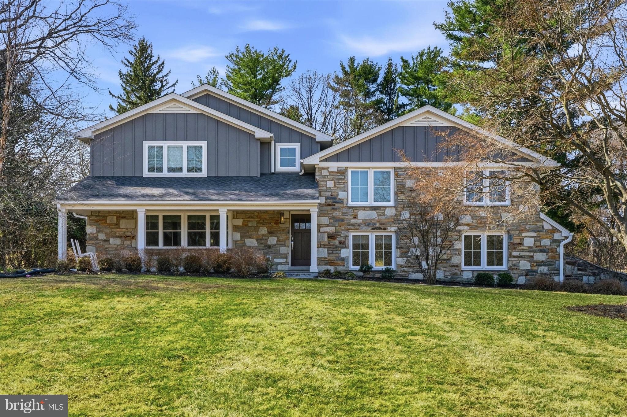 Step into a home that feels like a dream come true, where every corner invites you to pause and take it in. Light pours through towering windows, dancing across the rich hardwood floors, while a two-story foyer sets the stage for elegance and warmth. Imagine gathering in the open-concept great room: a soaring space with a stone fireplace, a dining area made for unforgettable evenings, and a family room with a built-in bar where laughter lingers in the air. The chef’s kitchen is pure perfection, stainless steel appliances, quartz countertops, soft-close cabinetry, a subway tile backsplash, and a generous center island where friends and family naturally gather. Step through sliding glass doors to a covered porch and a backyard that feels like your private oasis, lush, serene, and ready for both quiet mornings and lively evenings. Venture downstairs to discover a second family room with a cozy wood-burning fireplace, an elegant office, and a mudroom with clever built-ins. Upstairs, the main suite is a true retreat, complete with a spa-like bath, a frameless glass shower, and a generous walk-in closet. Sunlight spills into the princess suite, while four additional bedrooms, two of which are full suites, the others connected by a Jack-and-Jill bath, offer comfort and privacy for everyone. Every detail of this home, from recessed lighting to seamless indoor-outdoor entertaining spaces, feels intentional, thoughtful, and luxurious. Nestled on coveted Fawn Hill Lane in Penn Valley, this is more than a home; it is a story waiting to unfold, a dream that captures the heart and never lets go.