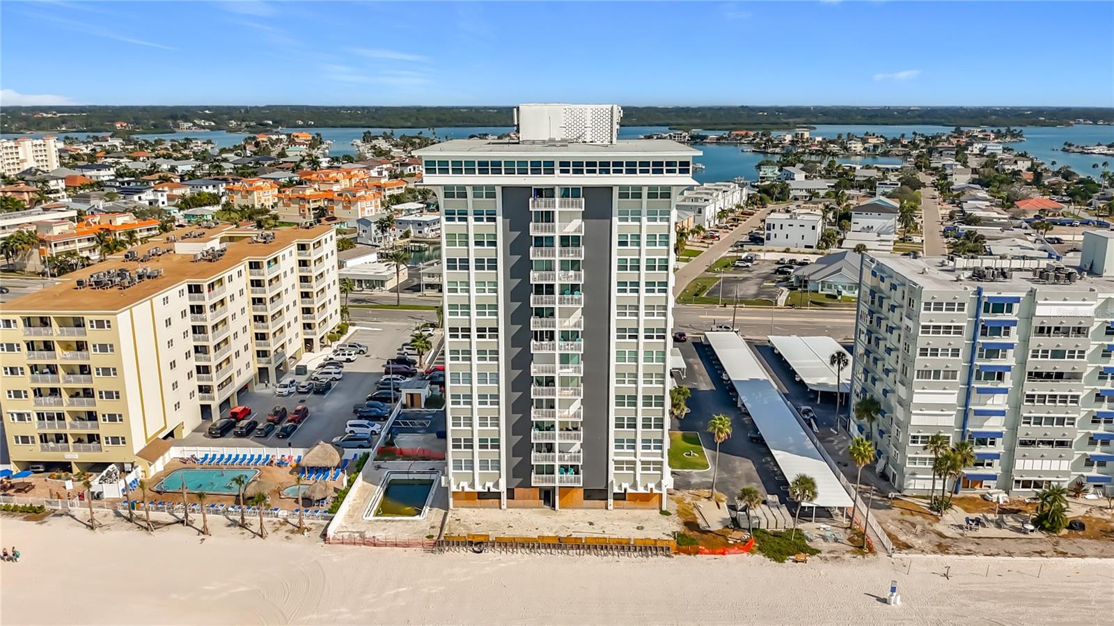 Back on the market after modernization upgrade!  NEW Custom Tile Walk-in Shower in Guest Bathroom (see pictures)!  Welcome to Club Redington, your serene oasis on the stunning Gulf of America! This delightful 13th-floor condo boasts 2 spacious bedrooms and 2 baths within a generous 1450 sq ft layout. You'll love the secured building entrance and the convenience of direct beach access, allowing you to enjoy sun-soaked days by the shore. This condo features newer bamboo floors in the living and dining areas, where hurricane-rated sliding glass doors & windows installed in 2021 showcase breathtaking views of the beach, Gulf, and intracoastal waterway from not one, but two balconies! Imagine taking in the spectacular city nightlights as you unwind. The kitchen features a cozy breakfast bar, perfect for casual dining, while the primary bathroom offers dual sinks for added comfort & the guest bedroom features a murphy bed for additional storage &/or added space. With covered parking, ample guest spaces, and amenities including a full-time onsite manager, outdoor BBQ, clubhouse with a kitchenette and billiards table, and a heated pool, you’ll find a perfect balance of relaxation and community. Located near a variety of dining, shopping, and entertainment possibilities, this condo is truly a dream come true!  Don’t hesitate to schedule your viewing today before it’s too late!