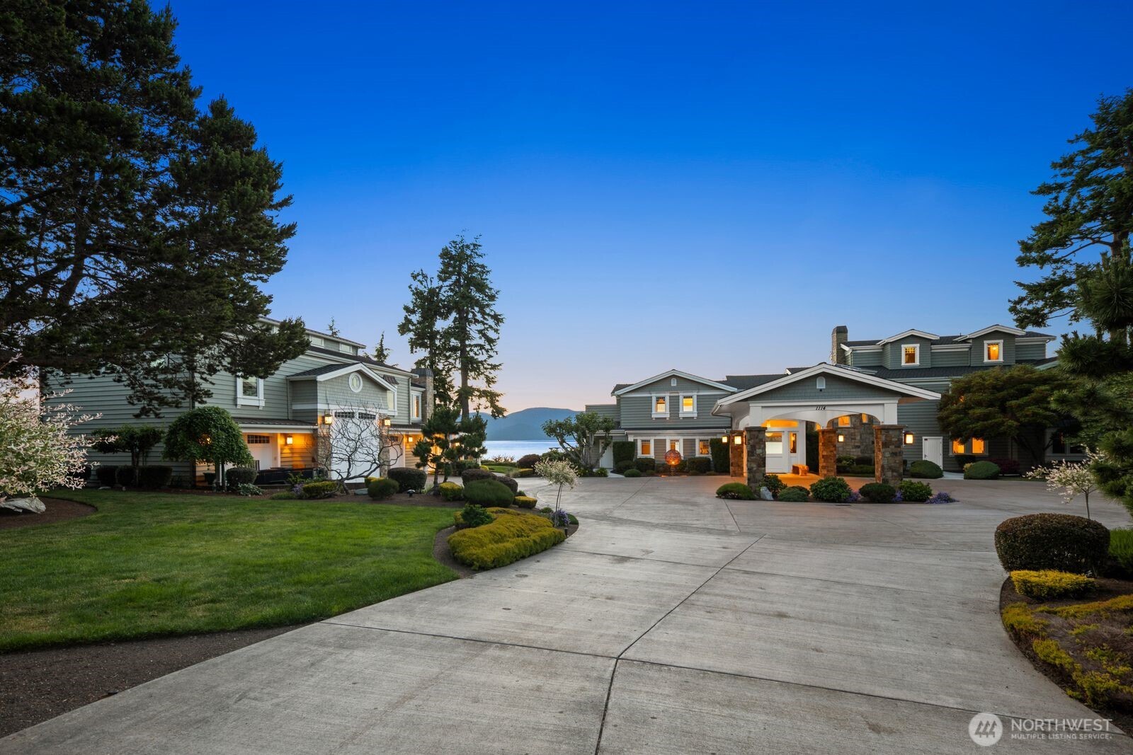 This gated destination waterfront retreat provides an irreplaceable setting to create lifelong cherished memories. Created as a 2-acre multi-generational haven, this iconic estate includes an exceptional stately manor with an elevator, a charming guest cottage, and caretaker’s quarters or second guest home. Inspired by its coastal setting and approx. 230’ waterside, every detail reflects timeless design, tailored craftsmanship, curated finishes, and uncompromising quality. Expansive windows frame panoramic views across the active Guemes Channel with ferries, yachts, and commercial boats. The main residence has multiple private suites, theater, game room, crows’ nest, casual and elegant gathering spaces, and seamless indoor-outdoor living creating an environment designed for grand entertaining or quiet relaxation. Meticulously maintained and continually enhanced, the estate features professionally designed landscaping with an ever-changing portrait of brilliant colors, a new professional pickleball court, and a large hot tub with an electric roof. From unforgettable sunsets to the rhythm of passing marine traffic, every element has been carefully considered to create an effortless, exceptional lifestyle. A waterfront compound of this scale, quality, and amenities within city conveniences is irreplaceable. Located just 60 miles from Seattle, this legacy property offers the rare distinction of drive-to island living, seclusion, yet restaurants and shopping just a mile away.
