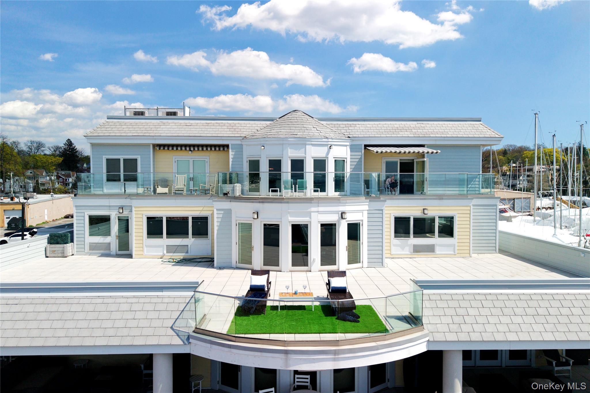 This exceptional 62+ waterfront residence offers 2,544 sq. ft. of interior living space, complemented by an expansive waterfront private patio of  2,782 sq. ft.—a rare and remarkable feature, with stunning views of Manhattan and City Island.Designed with the feel of a Presidential suite on a luxury cruise, this magnificent unit features: • A spacious primary bedroom suite with a large bathroom with heated floor, multiple closets, and sweeping water views • Two additional generously sized bedrooms • An additional 1.5 bathrooms (full bath with heated floor) • A large eat-in chef’s kitchen with high-end appliances and an oversized island • A living room with fireplace and dining area, both overlooking the terrace and Manhasset Bay • Beautiful hardwood floors and in-unit laundryAdditional highlights and premium upgrades include: • Custom closets and cabinetry throughout • Massive storage space • Backup generator available at the flick of a switch • Wine cooler • Video doorman and secure package room • Automatic door entrance from garage to elevators • Sub-Zero refrigerator and Wolf appliances • Automatic shades in the primary bedroom and living roomAdditional highlights include two indoor parking spaces with storage.Residents enjoy a stunning rooftop terrace complete with BBQs, a fire pit, and a putting green.