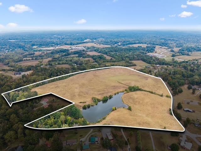 Outstanding development opportunity on 52 beautiful acres in Burns, Tennessee. Featuring a scenic 3-acre lake and over 3,700 feet of road frontage, this property offers a rare combination of natural beauty, accessibility, and development potential. The expansive acreage is ideally suited for a larger-lot residential community, offering the opportunity to create an attractive neighborhood with spacious homesites, scenic views, and a peaceful country setting.