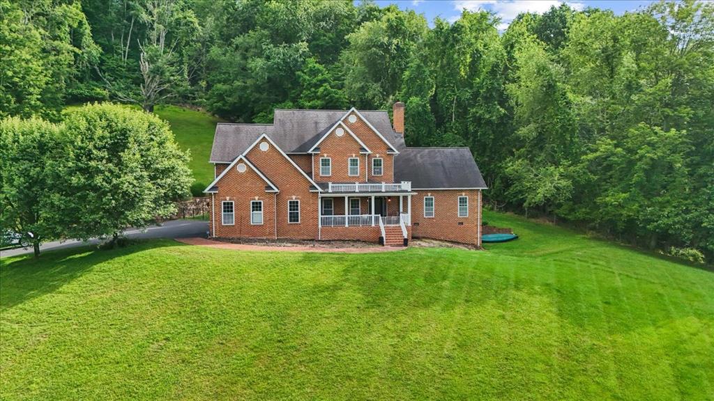 Welcome home to this 2.5 story brick estate perfectly situated on just under 3 acres, offering a blend of privacy, space, and convenience. Ideally located just minutes from Tazewell's beautiful main street, you'll enjoy the peaceful surroundings while remaining close to downtown shopping, dining and local attractions. Upon entry of this 4 BR, 3.5 BA home you will discover a spacious open-concept floor plan designed for both everyday living and occasional entertaining. The focal point in the living room is the floor to ceiling gas log fireplace. This space flows nicely into the modern kitchen with all newer stainless-steel appliances and breakfast area. The main level also features a formal dining room, but the current owners use that space for their "at home" gym. The large primary bedroom can also be found on the main level, featuring double walk-in closets, en-suite bath with jetted tub, step in shower and oversized vanity. The upper level of this home offers more than enough space for family and guests. It has 3 large bedrooms, all with wonderful closet space. Also on the upper level is a storage room that's perfect for storing seasonal items. The partially finished basement is ideal for the hobbyist of the house, a teenage hangout or guest suite. You will also find the lawn equipment garage in the basement area. The home is heated and cooled with a geo-thermal system. There is hardwood or ceramic tile flooring throughout. It has a main staircase as well as a back staircase just off from the kitchen. There are all new interior light fixtures. The oversized 2 car garage can handle more than just your vehicles. The brick patio in the back offers complete privacy if you just need to spend time with nature. This home is truly a special place!