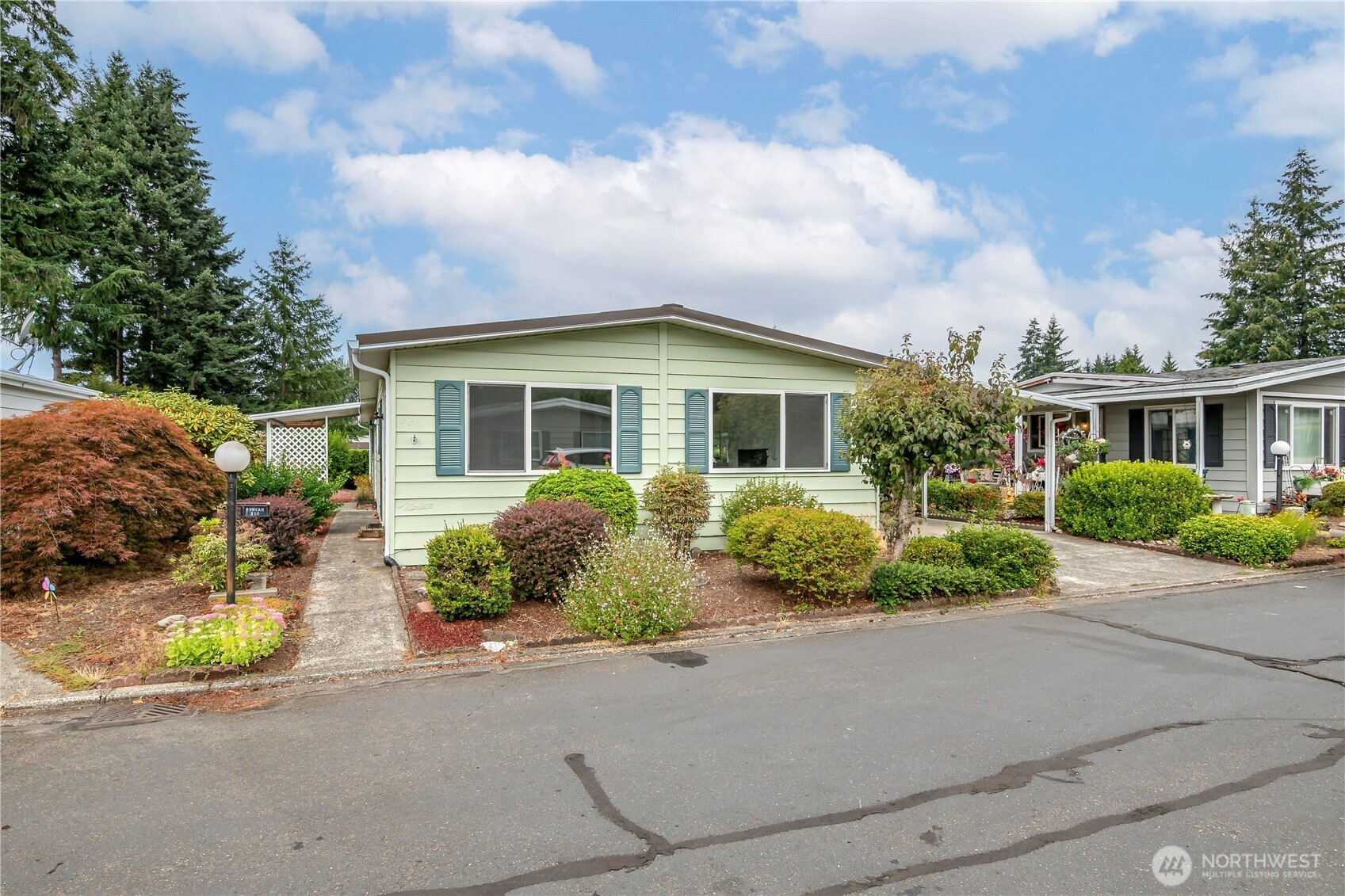 Here it is!  A beautiful large 1608 square foot home in the sought after Leisure Estates, a 55+ community in the Renton Highlands!  This 3 bedroom, 1.75 bath home features fresh paint, new carpet and vinyl throughout the home.  An open kitchen concept into the family room.  Convenient entry from carport to laundry room. A newer metal roof, complete under house foam insulation and an annually serviced furnace.  A complete pre inspection has been done with no red flag recommendations!  Move in with no worries!  You will find a comfortable patio just outside the family room with an extra long carport and storage shed.  Located in a quiet cul de sac, you will enjoy all the amenities the park has to offer such as pickle ball, a seasonal pool, fenced off leash dog park, community club house with sauna and exercise room. Maybe pitch a few golf balls up at the pitch n putt golf course! Meet your neighbors at weekly game nights and monthly bingo!!  This exceptional spotless home is just waiting for a new owner.  Don't miss out on so much house for such a reasonable price!