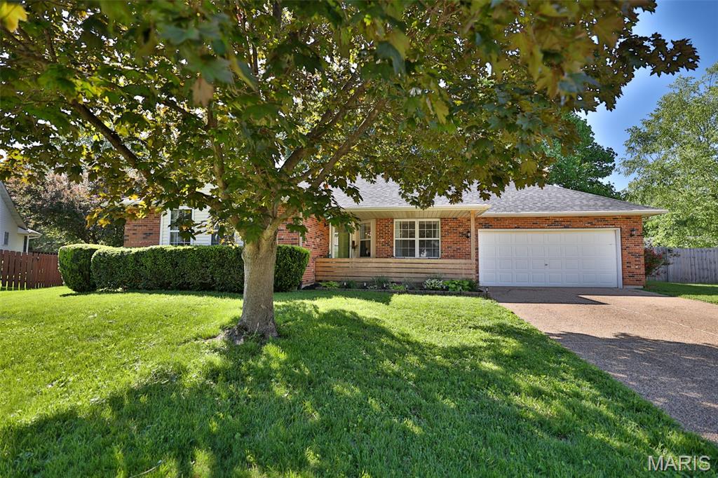Welcome to 6 Dunlap Sound in Edwardsville—a charming, well-maintained ranch nestled in a quaint cul-de-sac within desirable Dunlap Cove. This inviting home offers comfortable living with thoughtful updates throughout.Step inside to a warm and welcoming living room featuring vaulted ceilings, newer lighting throughout, and a stylish shiplap accent wall, all flowing seamlessly into the dining area—perfect for everyday living or entertaining. The beautifully remodeled kitchen (2016) showcases 36" custom cabinetry, granite countertops, and updated finishes, with all appliances included for added convenience.This home features three main-level bedrooms, including a spacious primary suite that provides a peaceful retreat with a private bath, tray ceiling, walk-in closet, engineered hardwood flooring, and its own shiplap accent wall.The lower level offers a large family/recreation area complete with a cozy wood-burning fireplace—ideal for relaxing or hosting gatherings. You'll also find a generous storage room, workshop space, extra vanity/sink, and a convenient laundry chute.Enjoy outdoor living in the expansive, fully fenced rear lawn, accessible through a sliding door off the dining room. The rear patio and additional paver firepit area overlook a private, green space—perfect for entertaining, gardening, or simply unwinding. Additional highlights include built-in garage storage, a storage shed, roof replaced in 2024, water heater (2025), furnace (2019), and a backup automatic generator for peace of mind.All kitchen appliances, as well as,  washer and dryer, will remain with the home. Centrally located near shopping, dining, and everyday amenities, this property offers both comfort and convenience.A great home in a wonderful neighborhood—don’t miss your opportunity to make it yours!