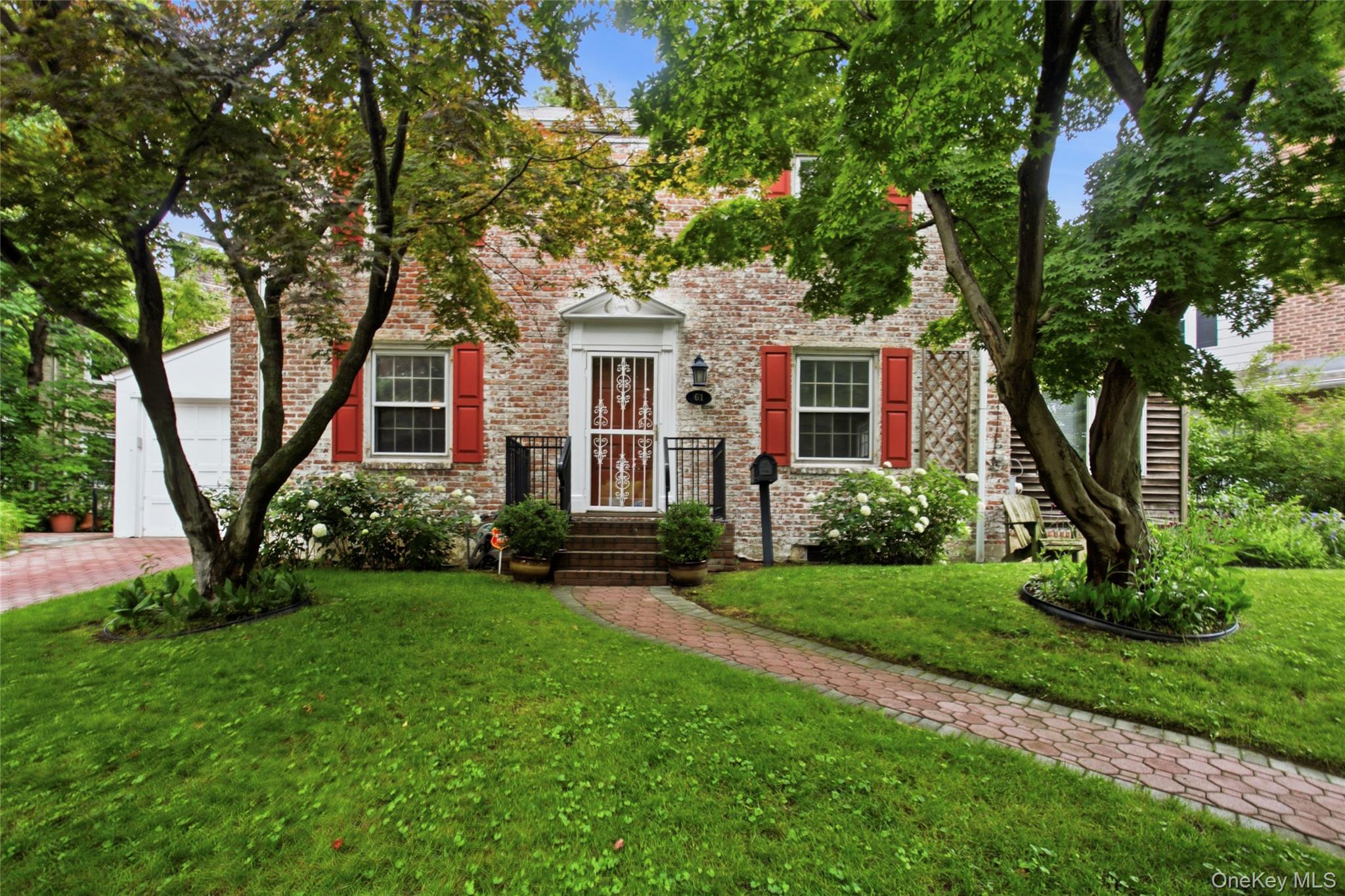 HIGHEST & BEST BY 7/9 -3PM  THANK YOU!    Hydrangeas, Irises, Heather, Lilacs and a small, low maintenance woodland garden surround this historic Williamsburg Brick Colonial. Built in 1937 to the highest standards by the Ludlow Real Estate Company, it was designed to be a light-filled, classic Center Hall home to stand the test of time. With many original details still well preserved - you'll find high ceilings, lovely, classic moldings & high-quality oak floors throughout coupled with renovations that meet today's comforts & expectations - new baths rooms, boiler, a young roof & individually zoned cooling in each room.  You'll also enjoy the well-planned kitchen with quartz counters, all Bosch appliances & special features only a professional chef will think off., like a pot filler faucet at the range. And, just outside the kitchen, for summer entertaining or just to relax there are 2 lovely brick & stone patios to enjoy. Ther spacious bedrooms all feature walk-in closets. All together the home exudes an aura of homey contentment. - Ludlow Park, with its tree lined streets is situated just north of Riverdale - it offers to best commute to mid NYC, to the Bronx or anywhere in the metro-NY area.  61 Beechwood Terrace is ideally located just   5 minutes from the Ludlow Metro North train station with only 35 min to Grand Central - or walking a little longer to NYC public or Express buses at the city line. Some folks say Ludlow Park feels like an extension of Riverdale.