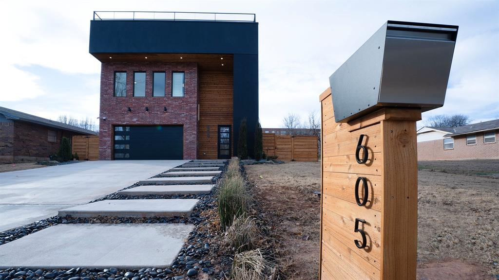 Welcome to a home where refined design meets city living in the heart of Oklahoma City. The exterior blends red brick, warm wood, and dark accents for a striking presence, and a custom walkway bordered by black river rock and curated landscaping leads to the front door.Inside, the entry offers built-in shelving and a bench with gold hardware, followed by a half bath wrapped in custom leopard wallpaper that sets the home’s bold tone. The open layout highlights clean lines and modern flow. The kitchen includes a marble waterfall island, pendant lighting, and custom acrylic cabinetry with integrated appliances. The living area centers around a streamlined fireplace framed by slatted wood and built-ins, plus a dedicated wine wall.Bathrooms throughout feature gold fixtures, marble showers, and floating vanities. The primary suite includes a walk-in closet connected to its spa-inspired bathroom with a freestanding tub inside an oversized walk-in shower with dual shower heads, a rainfall fixture, and a built-in wall shelf. Designer lighting, large mirrors, and a full-length mirror add a boutique feel.Upstairs, an open office or flex space sits beside the primary bedroom, partially enclosed with wraparound glass and a custom railing overlooking the staircase. A rooftop deck crowns the home with panoramic views, built-in seating, and welded railings, with the OKC skyline—including the Devon Tower—within reach.The backyard includes a concrete patio for dining, lounging, or a firepit. A block retaining wall with integrated steps leads to a deep grass yard enclosed by a privacy fence for a secluded outdoor retreat. Minutes from downtown, the home offers quick access to restaurants, parks, and cultural destinations.Leasing available for $6,000/month (12-month minimum) or rent-to-own with 20% down and approved application. Ask about receiving 1% of your loan amount in lender credits. Schedule your showing today with the listing agent to learn more.
