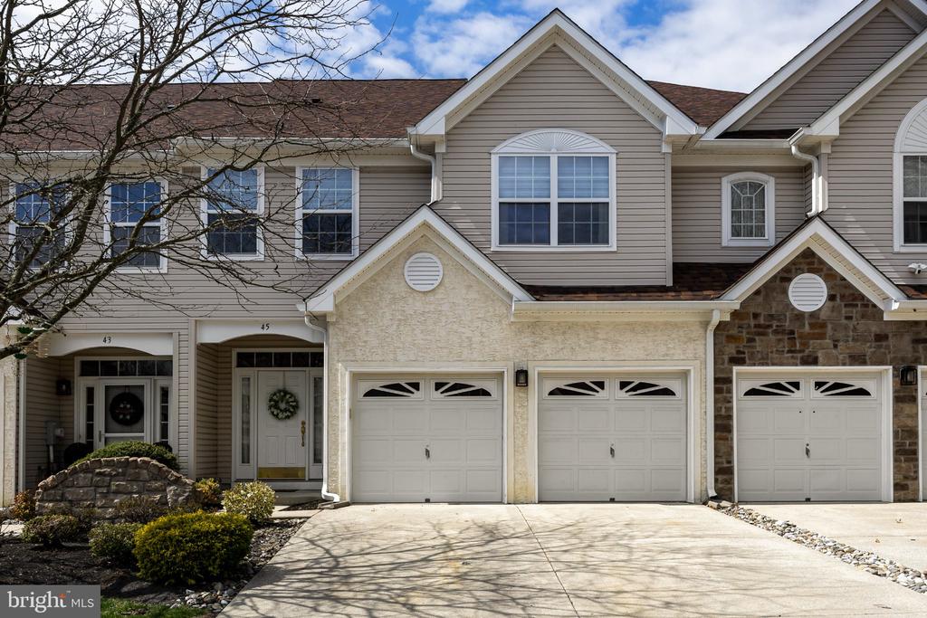 Welcome to 45 Tudor Ct., located in the highly desirable Marlton Woods community. Tucked away on a quiet cul-de-sac, this home offers the perfect blend of privacy, spacious living, and move-in ready convenience just minutes from all major amenities and Marlton Crossing. From the moment you arrive, you’ll appreciate the home’s charming curb appeal. Step inside to a beautiful interior filled with natural light and soaring ceilings that create an open, airy feel throughout. The hardwood-floored foyer leads into a stunning family room featuring dramatic high ceilings and a cozy gas fireplace, ideal for both relaxing and entertaining.The kitchen is thoughtfully designed with granite countertops, stainless steel appliances, ample storage, generous prep space, and a separate breakfast area. The main level also includes a formal dining room, a convenient pantry, a powder room, and access to the attached two-car garage with additional storage.Upstairs, the second level offers a spacious primary suite that serves as a private retreat complete with an attached bathroom featuring a soaking tub, separate shower, and double vanity. This level also includes two additional well-sized bedrooms, a full bathroom, and a dedicated laundry room.Step outside to your own private backyard oasis, complete with beautiful hardscaping, perfect for hosting gatherings or enjoying quiet outdoor moments.