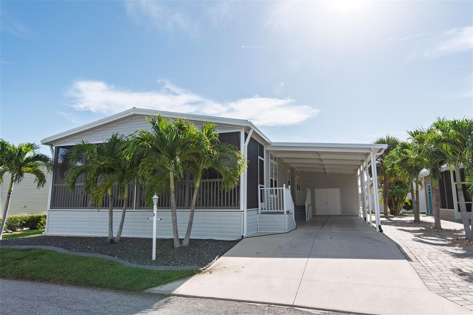 Welcome to Windmill Village, a sought-after 55+ resident-owned community offering an active and carefree lifestyle. This beautifully maintained 2020 Jacobsen model home features 2 bedrooms, 2 bathrooms, and 1,366 square feet of thoughtfully designed living space. Sold fully furnished and move-in ready, the home showcases modern finishes including drywall throughout, crown molding, ceiling fans, and luxury vinyl plank flooring in the main living areas and bedrooms. Transom windows fill the space with natural light, enhancing the open-concept layout that seamlessly connects the kitchen, dining, and living areas. The kitchen is equipped with stainless steel appliances, Formica countertops, a tile backsplash, and a center island with seating for three, while the dining area comfortably accommodates a table for four. The spacious primary suite offers a large walk-in closet and an en-suite bathroom with dual sinks and abundant storage. The second bedroom is generously sized, featuring a large closet and room for a king-size bed, while the second bathroom includes a tub/shower combination and a convenient linen closet. Enjoy outdoor living with a large screened-in front porch, perfect for relaxing or entertaining. The property also includes a sizable shed with ample storage space and room for a golf cart, a durable metal roof, mature landscaping with stone accents, paver details for low maintenance, and an extended driveway measuring approximately 68 feet long. Residents benefit from a low HOA fee which covers water, sewer, trash, lawn care, common area maintenance, and road upkeep, ensuring a truly hassle-free lifestyle. Windmill Village offers an impressive array of amenities including two private marinas, a boat ramp, trailer storage, horseshoe pits, shuffleboard, bocce ball, billiards, indoor pickleball, and a large community center with a variety of clubs and activities. The Pavilion by the heated pool provides a welcoming space for social gatherings. Located in Punta Gorda, consistently recognized as one of the best small places to live, this home offers both comfort and community. Please note that the purchase price does not include the $18,285 buy-in share and bond, which is refundable upon resale. Don’t miss this opportunity to own a stunning home in a vibrant waterfront community—schedule your private showing today.