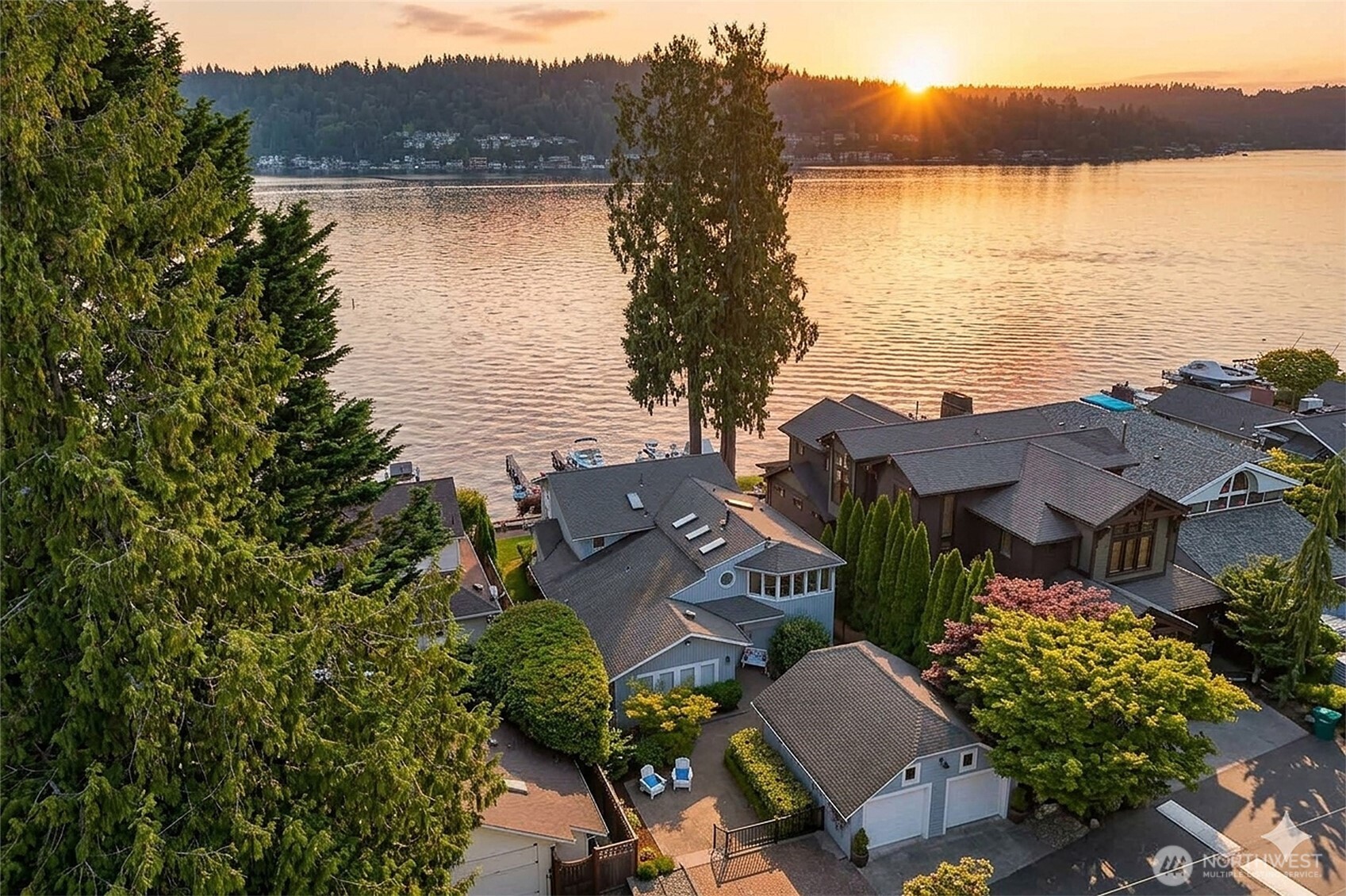 A coveted South Lake Sammamish Waterfront Opportunity! Claim your position on the premier, sun drenched south shore of of Lk Sammamish. Rarely available in this sought after area, enjoy a highly welcoming & active community experience. This retreat balances modern luxury & a relaxed PNW lifestyle offering a seamless connection to the water alongside thoughtfully updated living spaces. The lakeside features a wrap-around deck, low maintenance lawns cascading down to a private dock with boat & jet ski lifts & a custom stone firepit. Inside, the home embraces a refined coastal-modern aesthetic defined by crisp white millwork, warm hardwood floors & expansive windows with natural light framing breathtaking, unobstructed views over the water. The modernized and reconfigured chef's kitchen boasts stainless steel appliances, striking quartz countertops, a massive central island & a walk-in pantry. The remodel continues with the primary suite with a private spa-like bathroom with its freestanding soaking tub, seamless glass walk-in shower & double vanity. Experience the dramatic scenery from the upper-level view deck, the ultimate vantage point for watching the sunset over the lake, quiet relaxation time or your morning coffee. 2-car garage & 2 side by side parking spaces, brick-paver driveway & professional landscaping. This unbeatable location ensures an easy commute to the major global tech hubs, offering the perfect balance of a secluded lakeside sanctuary & urban convenience.