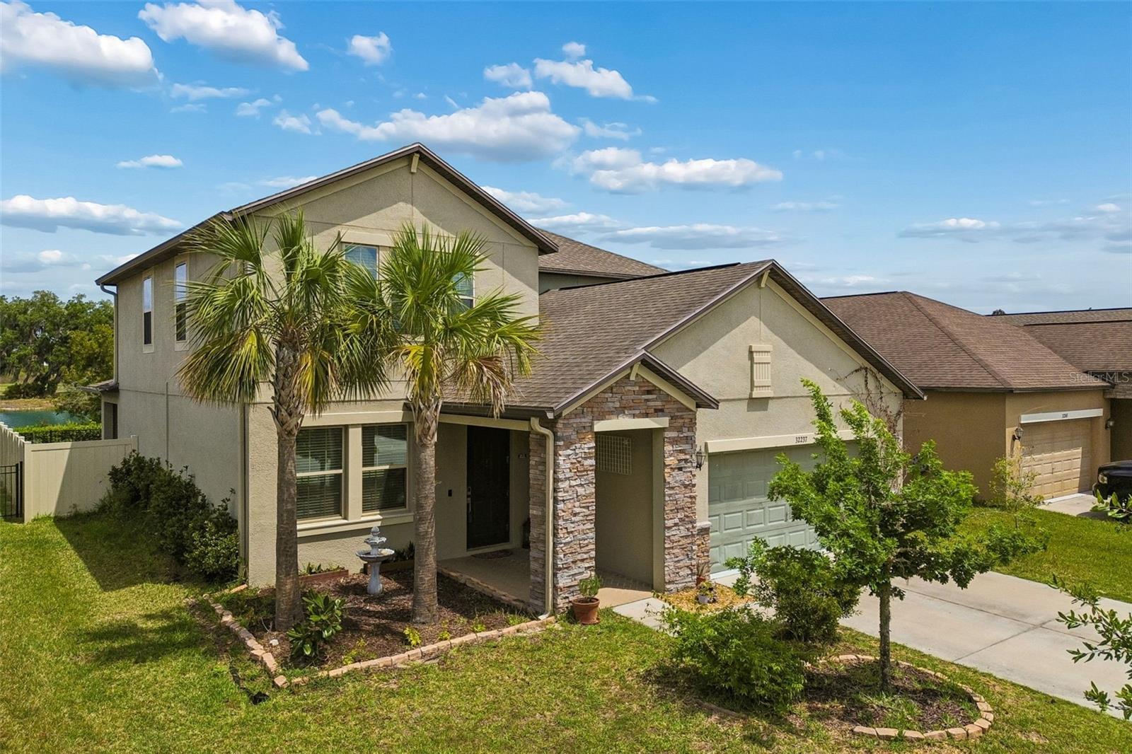What truly sets this home apart is the backyard. Overlooking a peaceful pond, this outdoor space offers a sense of privacy and open view. The fully fenced yard allows for a private setting while still providing the ability to step just beyond the fence and walk along the water. It’s a setting that can be enjoyed daily, whether for relaxing or spending time outdoors.Located at 32237 Watoga Loop in the Union Park community of Wesley Chapel, this two-story home offers 2,529 square feet of living space with 4 bedrooms, 3 bathrooms, and a 2-car garage. The open-concept kitchen features upgraded cabinetry, a breakfast nook, and a central island overlooking the family room, creating a functional layout for everyday living.The first floor includes a designated office space, as well as a bedroom and a full bathroom, providing flexibility for guests or multi-generational living. Additional living areas are located on the second floor.Recent improvements include a fully fenced yard, renovation of the first-floor bathroom, installation of gutters, and replacement of carpet on the stairs, spare room, and second-floor hallway with laminate flooring.The covered patio extends the living space outdoors and connects directly to the backyard.Union Park offers community amenities including a pool, fitness center, splash park, dog park, and walking trails. The neighborhood also features ULTRAFi, providing high-speed internet connectivity throughout the community.Conveniently located in Wesley Chapel with access to I-75, shopping, dining, and healthcare facilities. The area is known for its continued growth and access to public schools.
