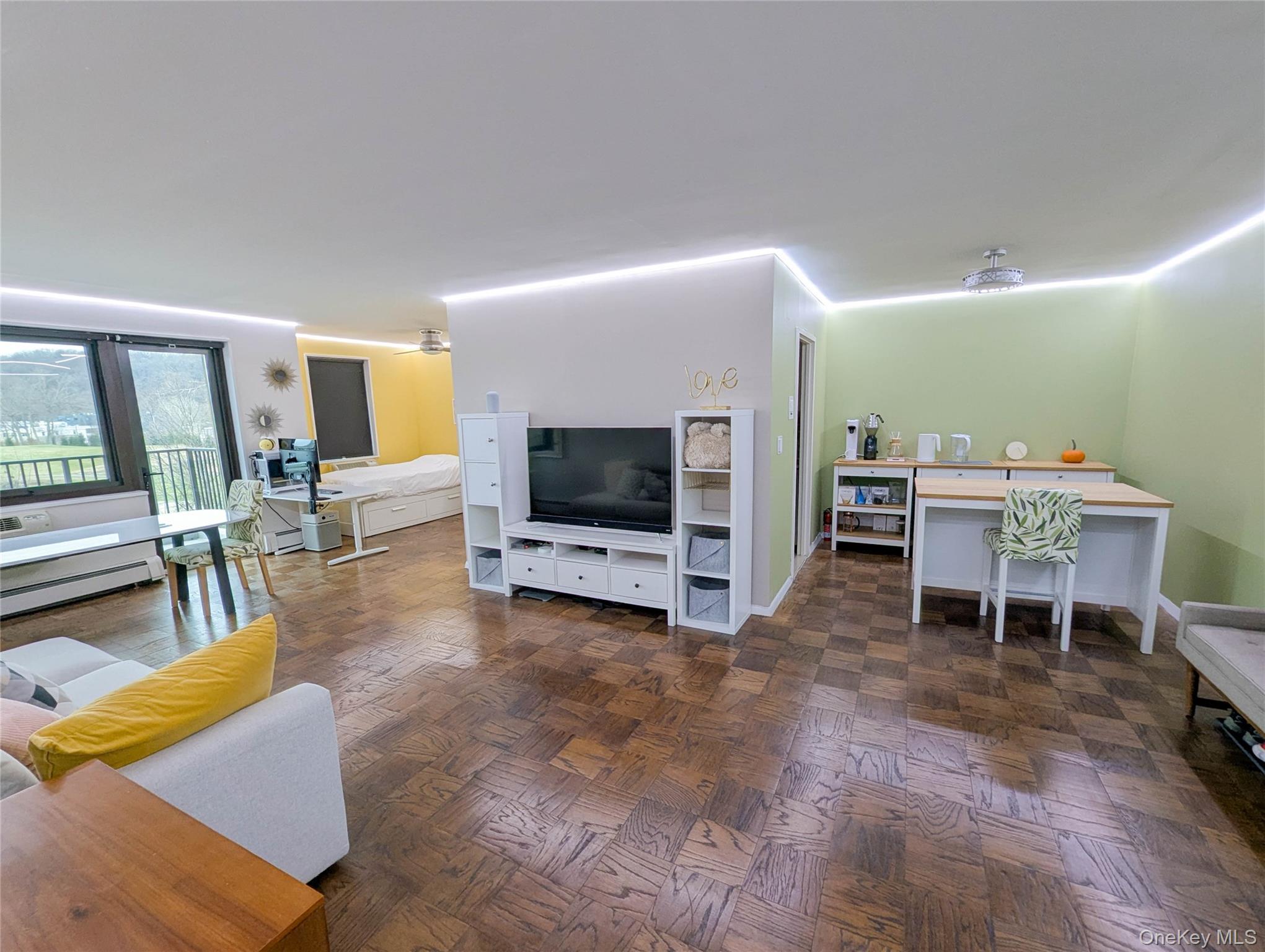 This spacious (950sq ft) junior 4 one-bedroom features a spectacular view of the Scarsdale Golf Course from ALL windows with plenty of sun year-round (Southwest exposure). Watch the sunset and enjoy bird watching from the comfort of your roomy balcony. The unit features open flooring and hardwood floors, a modern updated kitchen with granite countertops and GE Profile / Bosch appliances, and a sophisticated smart programmable lighting system across all rooms (wall switch + mobile phone + voice control). The large primary bedroom fits a king-sized bed and features a custom floor-to-ceiling built-in triple closet system. Junior 4 alcove serves as an additional bedroom or office space with window and a closet. Comfortable space-saving smart ceiling fans in both bedrooms. ASSIGNED GARAGE space within building. 5-minute stroll to Metro North train station (35min express to Grand Central Terminal). Short distance to grocery, shops, restaurants, and hiking paths.