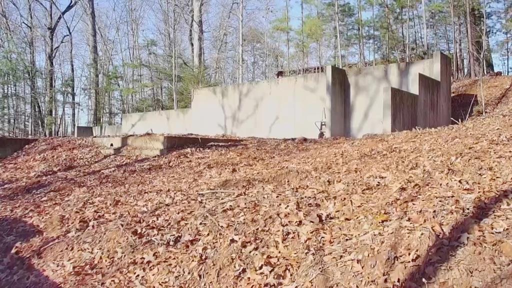 This 1.26 acre lot has foundation, septic, water, and power!!!  Ready for your dream home with infrastructure in place.  The house seat area and place for yard is cleared.  Whether you're planning a full-time retreat or weekend escape, this provides a strong head start and perfect setting!  Home plan also available.  One of the most scenic gated communities & roads are paved.