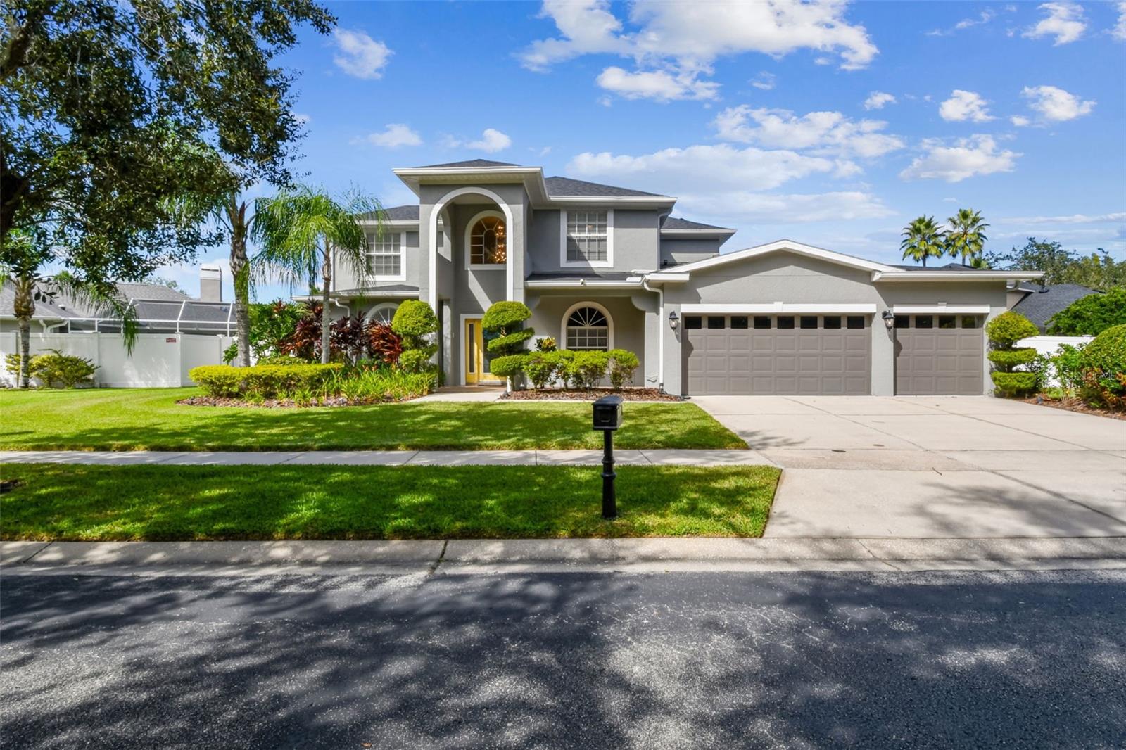 Welcome to this stunning and meticulously maintained Tampa Palms residence, a rare find with over 3,200 square feet of living space on a generous homesite of almost 1/3 of an acre.   Lots of room for the littles to run around and play.  There's also plenty of room for you to relax and sip on your morning coffee or unwind after a long day on this enormous back patio with pavers, designed to be beautiful and functional.    This well Designed home offers both comfort and style with this flexible layout, you can use the living spaces as you desire.  The is expansive New Tampa home features 4 spacious bedrooms, 3 1/2 baths, and a 3 car garage, perfect for a home with multiple drivers / cars. The thoughtfully designed floor plan is one-of-a-kind within the community and includes a luxurious primary suite on the main level with dual walk-in closets and a spa-inspired bath complete with a soaking tub, separate walk in shower, and dual vanities. The heart of the home is the gourmet open kitchen, beautifully appointed with solid wood cabinetry, stone countertops, a butler’s pantry, a walk-in pantry, and a large island with seating for five, creating the perfect setting for entertaining and family gatherings as it flows effortlessly into the large family room and back patio through the beautiful french doors. The living areas of this home showcase high ceilings, crown molding, and abundant natural light.

Step outside to a sprawling covered lanai designed for year-round enjoyment, featuring a full outdoor kitchen, stylish paver patio, and new outdoor ceiling fans, all overlooking a lush, private yard with ample space for a future pool (if desired) or recreational area. Upstairs, three additional bedrooms include one with its own en-suite bath and two connected by a Jack and Jill bathroom, each with generous walk-in closets. This home has been thoughtfully updated with a NEW ROOF in November 2024, a dedicated EV charger, and a reverse osmosis water filtration system, combining modern convenience with lasting value. Located within a small GATED COMMUNITY within Tampa Palms, where residents enjoy added privacy and peace of mind. Smart home features include Wi-Fi–enabled garage doors, thermostats, and sprinkler controls, making daily living effortless and efficient. Every detail has been cared for, with freshly steamed carpets and tile throughout. Perfectly located near I-75, I-4, USF, and the New Tampa Rec Center, making the commute to work easily accessible. This home offers top-rated schools, shopping, dining, and entertainment all nearby in booming Wesley Chapel or head south and enjoy everything a Major City has to offer in Tampa. Membership opportunities available for GOLFERS and Socialites at Tampa Palms Golf & Country Club. A current survey is available, making your transition seamless. This exceptional property combines timeless design, modern upgrades, and an unbeatable location—making it the perfect place to call home.