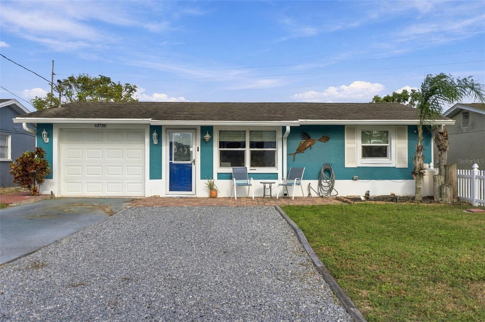 Experience the essence of Florida waterfront living in Hudson Beach Estates, where direct saltwater canal access places the Gulf of Mexico just minutes away by boat. Thoughtfully designed for those who appreciate life on the water, this three-bedroom, two-bath block residence pairs coastal ease with an impressive collection of boating and outdoor amenities.A 50-foot seawall frames the waterfront, complemented by a 2024 composite dock, 10,000-pound covered boat lift, floating dock, and a dedicated fish-cleaning station with water and power—creating an exceptional setup for boating, fishing, and effortless days on the Gulf.Inside, distinctive poured metallic epoxy flooring flows throughout the home, lending a polished, contemporary character. The kitchen features crisp white shaker cabinetry, quartz countertops, a mosaic tile backsplash, stainless steel appliances, and a generous breakfast bar. An inviting living area with a dry bar opens through sliding glass doors to an expansive screened lanai with ceiling fans, seamlessly extending the living space outdoors.The primary suite offers a walk-in closet and private bath with a bidet and striking tiled vanity wall. A beautifully appointed secondary bath features a glass-enclosed shower and vessel sink.Outdoors, the home truly embraces the Florida lifestyle. A covered outdoor kitchen with a stacked-stone bar and masonry grill overlooks a paver courtyard surrounded by raised garden beds and fruit trees. An outdoor shower, porch swing, and storage shed complete this private waterfront retreat.Additional improvements include a 200-amp electrical panel and tankless water heater, both added in 2022, along with a one-car garage with laundry hookups.Ideally positioned near Hudson’s waterfront restaurants and marinas with convenient access to US-19, this is more than a home—it is an invitation to experience Florida’s Gulf Coast from the water’s edge.