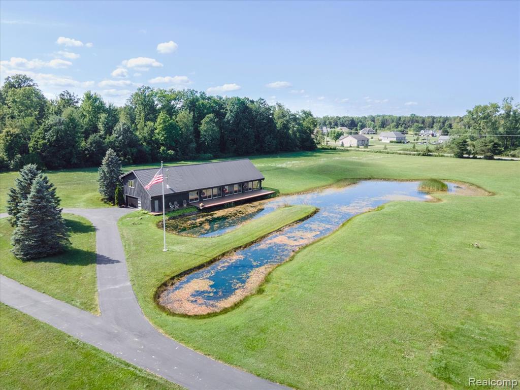 Welcome to your dream live/work opportunity! This beautifully maintained 3-bedroom, 2.5-bath home offers 3,528 square feet of comfortable living space on a meticulously maintained 12.9-acre property, complete with a serene pond and expansive countryside views. The home features high ceilings and large windows that flood the interior with natural light, creating an open and airy feel throughout. Enjoy spacious living areas, a large kitchen perfect for entertaining, and a 2-car attached garage with a generous storage loft, ideal for hobbyists, storage, or a future workshop. A true highlight of the property is the fully operational, 50-run dog kennel and boarding facility. This is a rare, exceptional opportunity to own and operate a fully equipped, licensed dog kennel and boarding facility. With a longstanding reputation for excellent animal care and service, this business is well-known in the community and beyond, making it ideal for both seasoned pet care professionals or newcomers seeking a ready-to-go operation. Following the recent passing of the beloved owner, this trusted business is now looking for someone new to step in and continue its legacy. Fully operational and turnkey, you can walk in and start running the business. The facility includes indoor and outdoor runs, a dedicated grooming area, and a private office, all designed for efficient daily operations and top-tier animal care. Two new outbuildings offer additional storage for equipment or supplies, and the stunning acreage provides plenty of room for recreation, expansion, or additional business use. If you're  looking for a quiet country lifestyle, a profitable business opportunity, or both, this unique property delivers unmatched flexibility, functionality, and pride of ownership in a professionally maintained setting. Approval of land split is expected soon and a survey will be available upon request  mid-October 2025. The aerial parcel view in public records is not accurate as of 10/3/2025.