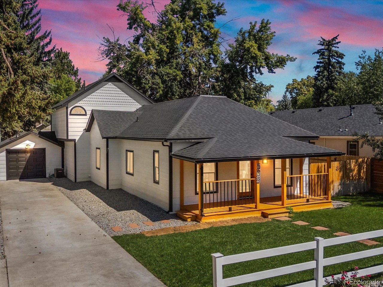 Welcome to 509 W 5th Street in Loveland, a beautifully updated sophisticated bungalow-style home blending original character with modern finishes. Offering 3 bedrooms and 21/2 bathrooms.Step inside to a bright, open interior featuring luxury vinyl plank flooring, new doors, fresh paint, exposed wood beams and modern lighting. The remodeled kitchen is the heart of the home, showcasing new cabinetry, quartz countertops, a center island with seating, stainless steel appliances, modern backsplash and abundant storage. The kitchen flows seamlessly into the dining and living areas, creating an inviting open-concept gathering space.The renovated bathrooms feature smart toilets, elegant tile, glass-enclosed showers, contemporary vanities and stylish fixtures. The primary suite is filled with natural light and offers a vaulted ceiling, generous closet space and a spa-inspired bathroom with a freestanding soaking tub and separate glass-enclosed shower.Major improvements include a new roof, gutters, siding, electric water heater, one new furnace, two new A/C systems, interior and exterior paint, front deck, new sod, and sprinkler systems in both front and backyard.The remodeled attached garage is heated and cooled and includes hot water, offering flexibility for vehicles, hobbies or a workshop. The extended driveway offers space for up to five additional vehicles, with room for an RV, boat, recreational toys or guest parking.Enjoy a spacious fenced backyard with mature trees, new sod, a deck, brick patio, storage shed and a dedicated gourmet outdoor entertaining area-ideal for cooking, gathering with friends and family, or relaxing outdoors. The covered front porch and landscaping complete the home's welcoming curb appeal.Modern updates, generous parking, RV and recreational-toy space, a heated and cooled garage, gourmet outdoor entertaining area and an impressive backyard make this Loveland home truly special.