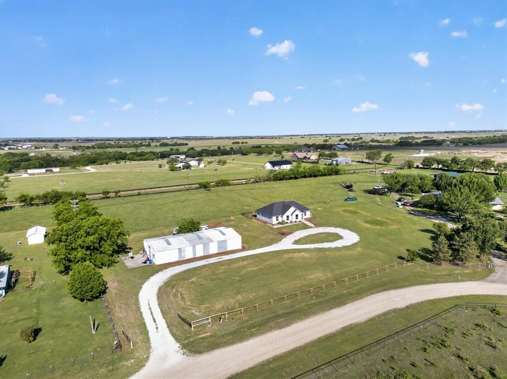This beautiful 4-bedroom, 2-bathroom home, built in 2022, offers modern comfort with the charm of peaceful country living. Designed with an open-concept layout, the home features a spacious living area that flows seamlessly into the kitchen and dining spaces—perfect for entertaining or everyday living. Large back windows showcase stunning sunset views, bringing natural light and serene scenery right into your home.Situated on 4 acres, this property is ideal for those looking to enjoy a rural lifestyle with flexibility—horses and chickens are welcome, and there are no known restrictions. A circular gravel driveway provides easy access and plenty of parking.In addition to the home, the property includes an impressive 75 x 40 metal building that is insulated and equipped with AC ducting, offering endless possibilities for a workshop, storage, or business use.Located between Ponder and Justin, Texas, this property combines the tranquility of country living with convenient access to nearby towns. Whether you’re looking for space to spread out, room for animals, or a versatile outbuilding, this property has it all.