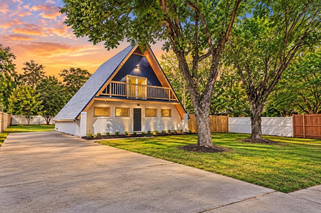One-of-a-kind, beautifully remodeled A-frame home in Grapevine! This distinctive 3-bedroom, 2.5-bath home combines unique architectural character with stylish modern updates. The dramatic A-frame design, soaring roofline, exposed ceiling beams, and beautiful Luxury Vinyl plank wood-look flooring create an inviting atmosphere unlike your typical home.Step inside to discover a spacious, open-concept living and dining area that flows into a beautifully updated kitchen featuring quartz countertops, a full quartz backsplash, attractive wood cabinetry, black hardware, stainless steel appliances, a smooth-top electric range, and a convenient breakfast bar. Fresh neutral paint, updated lighting, modern ceiling fans, and crisp white trim complete the contemporary look.The primary bedroom is conveniently located downstairs, while two generously sized upstairs bedrooms offer plenty of flexibility for family, guests, or a home office. The second floor also features a full bathroom and access to a charming balcony overlooking the front of the property.Outside, enjoy a large, fenced yard shaded by beautiful mature trees, an extended concrete driveway offering abundant parking, and a covered patio perfect for relaxing or entertaining. An additional enclosed room provides even more flexible space.With its striking architecture, extensive interior updates, spacious lot, and desirable Grapevine location, this home offers a rare combination of personality, comfort, and modern convenience. If you're looking for something beyond the ordinary, this is a must-see!