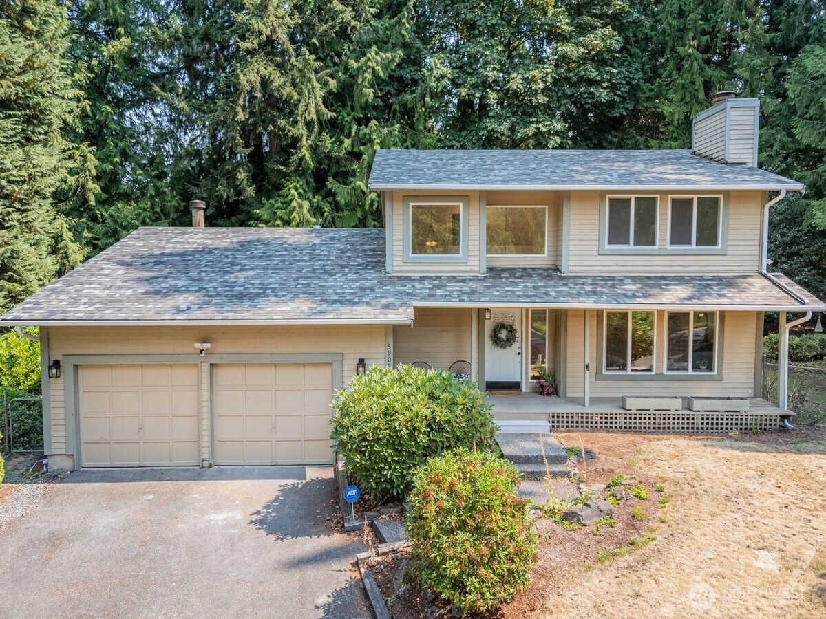 Welcome to this beautifully updated traditional two-story home in the highly desirable Picnic Point area of Edmonds, nestled on a quiet cul-de-sac. Situated on a generous ¼-acre lot, the backyard offers a private park-like setting with mature landscaping, peaceful surroundings, & plenty of room to relax or entertain. The thoughtfully designed main level features a warm and inviting living room with a cozy wood-burning fireplace that flows seamlessly into the dining area. The kitchen offers stainless steel appliances, a sunny eating area, and opens to the spacious family room, while an updated powder room completes the main floor. Sliding doors from the dining room, kitchen,& family room lead to new backyard decks, creating effortless indoor-outdoor living. Upstairs, the tranquil primary suite is your private retreat, featuring an updated bath, walk-in closet, and a new deck overlooking the serene backyard. 2 additional bedrooms and a full bath provide comfortable space for everyone. Enjoy peace of mind knowing the major updates have already been completed. New in 2026: roof, gutters, attic insulation, double-pane windows and sliding doors, interior paint, carpet, laminate hardwood flooring, updated bathrooms, new decks, and crawlspace cleanout with new vapor barrier and insulation. Offering an exceptional combination of privacy, generous outdoor space, and extensive updates, this move-in-ready home is a rare opportunity in one of Edmonds' most sought-after neighborhoods.