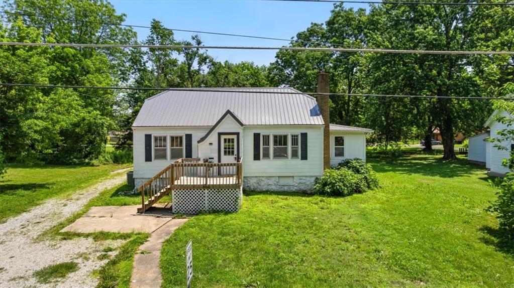 Full of charm and thoughtful updates, this inviting 3-bedroom, 1-bath home is move-in ready and full of character. Inside, you’ll find updated paint, newer vinyl flooring and carpet, and updated fixtures throughout. Arched doorways add timeless appeal, and the main floor mudroom—right off the kitchen—now offers convenient laundry access. The unfinished basement has both interior access and a second entry from the mudroom, providing flexibility for storage or future use. Situated on a spacious double lot with a newer metal roof, there’s plenty of room to add a garage or shop. Enjoy relaxing on the front deck or hosting friends around the backyard firepit. A welcoming space with room to grow!