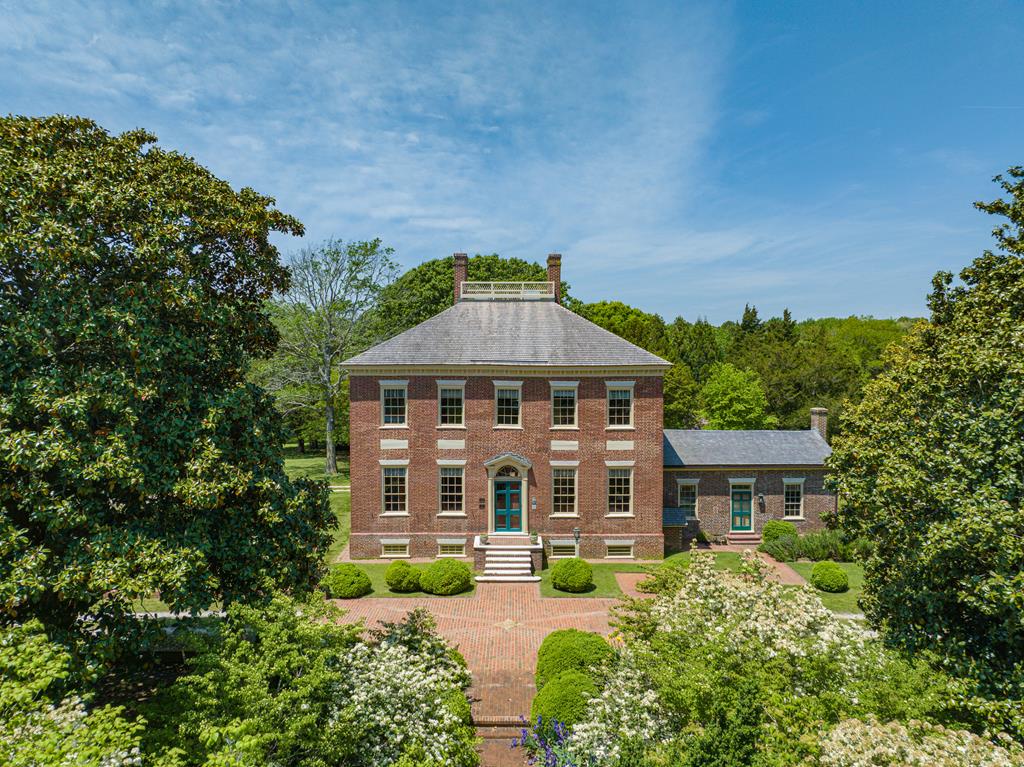 Wharton Place, circa 1805, has long been regarded as one of the finest period homes on the Eastern Shore of VA. With 100.4 acres (+/-) and nearly 2,500 ft of Assawoman Creek frontage, its views extend to Wallops Island and the Atlantic Ocean. There are approximately 59 acres of farmland, 20 acres of woods, and 12 acres of tidal marsh, with the remaining acreage being lawn and gardens. Placement under a conservation easement in 2006 with VESLT reflected not only its place in history, but also protected its future. While significant restorations have taken place since the 1940s, most recently with Williamsburg-based architecture and paint specialists, modernizations have been made to accommodate 21st century living. This property is well suited for architecture and outdoor enthusiasts.