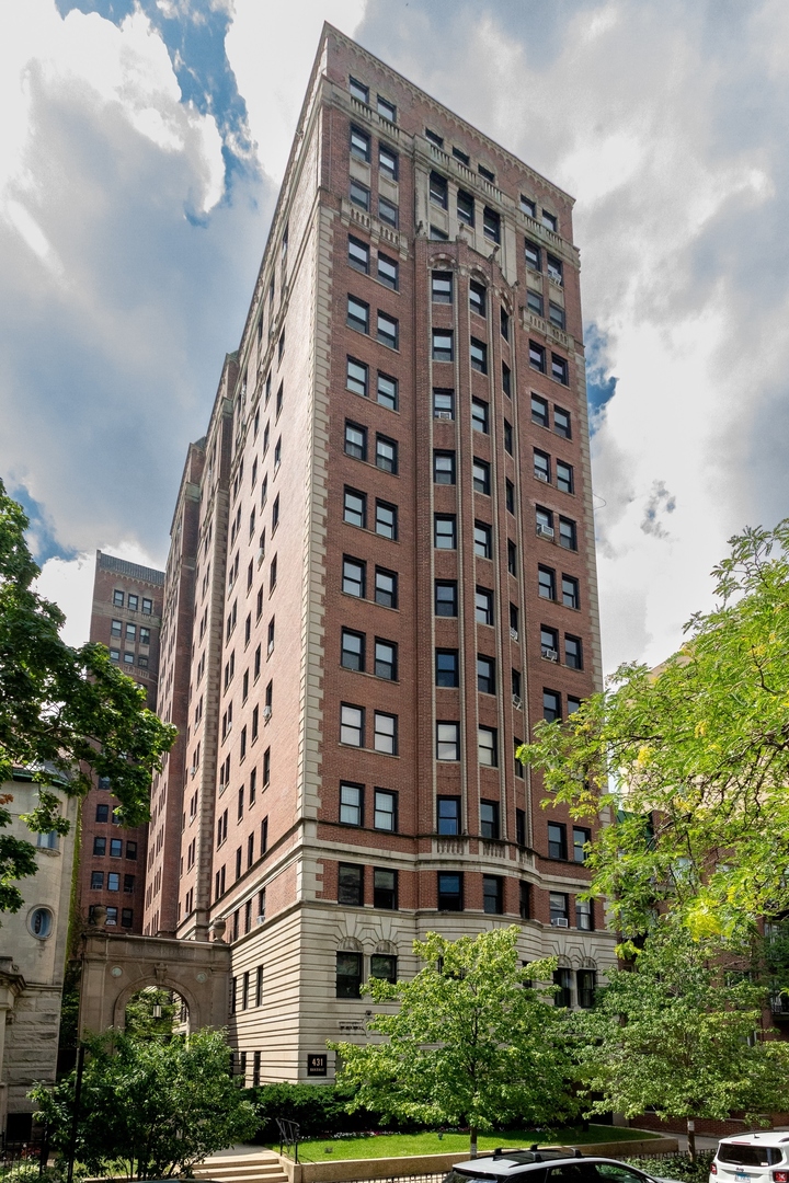 Esteemed and refined pre-war vintage condo in vibrant Lakeview East! Originally designed by architects E.F. Quinn and R.T. Christiansen, this exquisite two bedroom, two bathroom home in the historic Oakdale Towers combines both sophistication and style with modernity and comfort. Positioned on a tree lined, one-way street and with only two units per floor, the residence offers both quietness and privacy for the most discerning buyer. Upon entering, you are welcomed by a grand foyer showcasing the gorgeous arched doorways and original millwork, all illuminated by adjustable can LED lighting. The large living room is encompassed by picture frame north-facing windows and anchored by a marbled surround decorative fireplace. In the formal dining room, built-in shelving systems offer a creative option for open concept storage and the south-facing windows showcase the dramatic skyline view making for the perfect setting to entertain. The sleek kitchen includes stainless steel appliances, a gas range and exhaust hood, dishwasher, plenty of storage space and 2 exposures which supply dazzling treetop views of the surrounding LakeView neighborhood. Original hardwood flooring extends throughout the entirety of the flat and into both bedrooms. The primary bedroom is highlighted by a vintage stained glass window and generously sized closet. The attached primary bathroom includes a spa-like shower system and pristinely kept classic features such as the original porcelain console sink and mid-century modern tiling. The sizable second bedroom also offers an attached bathroom which was fully remodeled and includes Kohler finishes and a freshly glazed bathtub. Additional updates including high-end Rejuvenation and Schoolhouse finishes, central air conditioning, rewired original light fixtures, fresh paint and new windows complete the residence. Building amenities include a private storage unit, a well-equipped fitness center and a fully furnished rooftop deck offering magnificent city views. While the building does not offer on-site parking, there are several convenient rental options within a few blocks. Just a short walk to everything on bustling Broadway, the lakefront, Diversey Driving Range and Lincoln Park Zoo and easy access to public transportation.